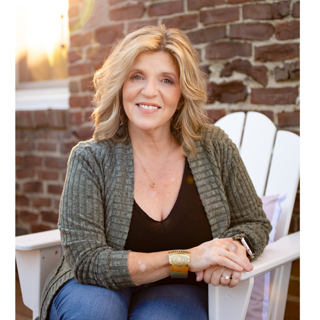 Amy King Seated Brick Wall 2500x1500 Resize.png