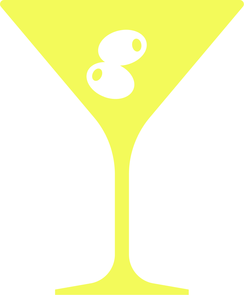 Yellow cocktail glass with black olives in the drink.