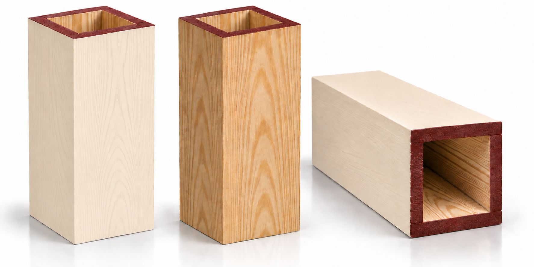 Three wooden rectangular blocks with red decorative edges on a white background.
