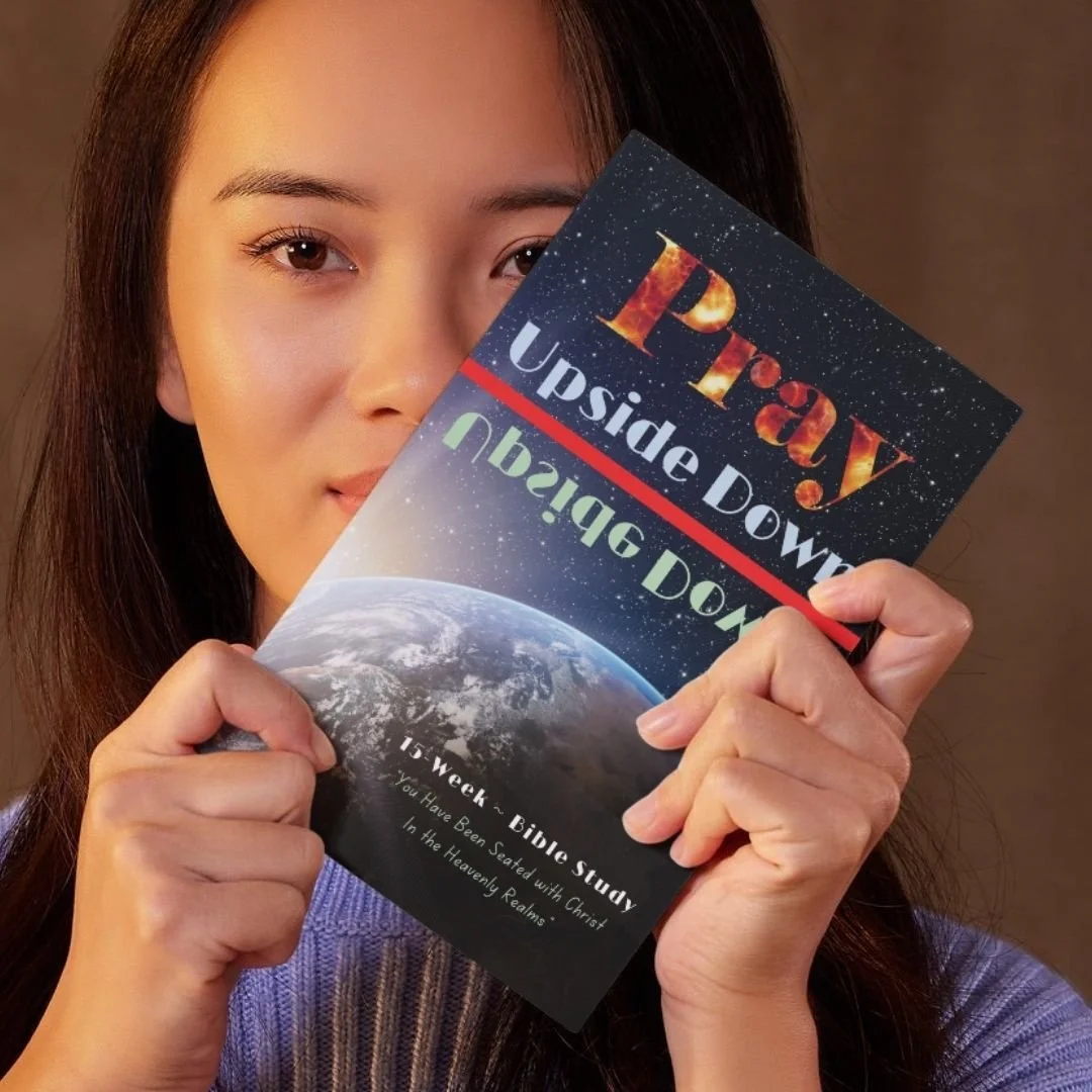 Woman holding Pray Upside Down, a 15-week Bible study with an Earth-from-space cover