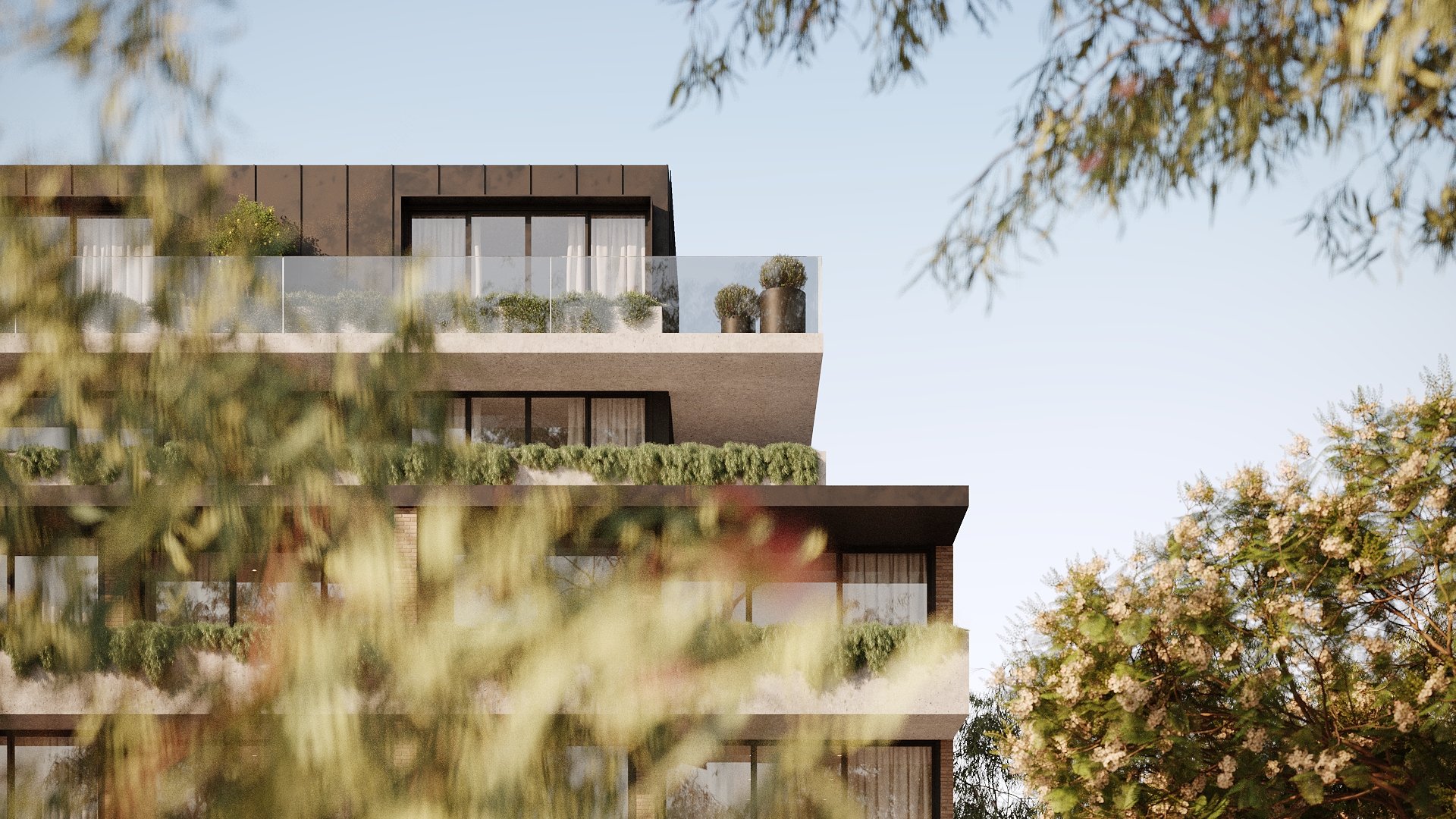 Modern multi-story apartment building seen through trees with flowering branches, featuring balconies with glass railings and potted plants, against a clear sky.