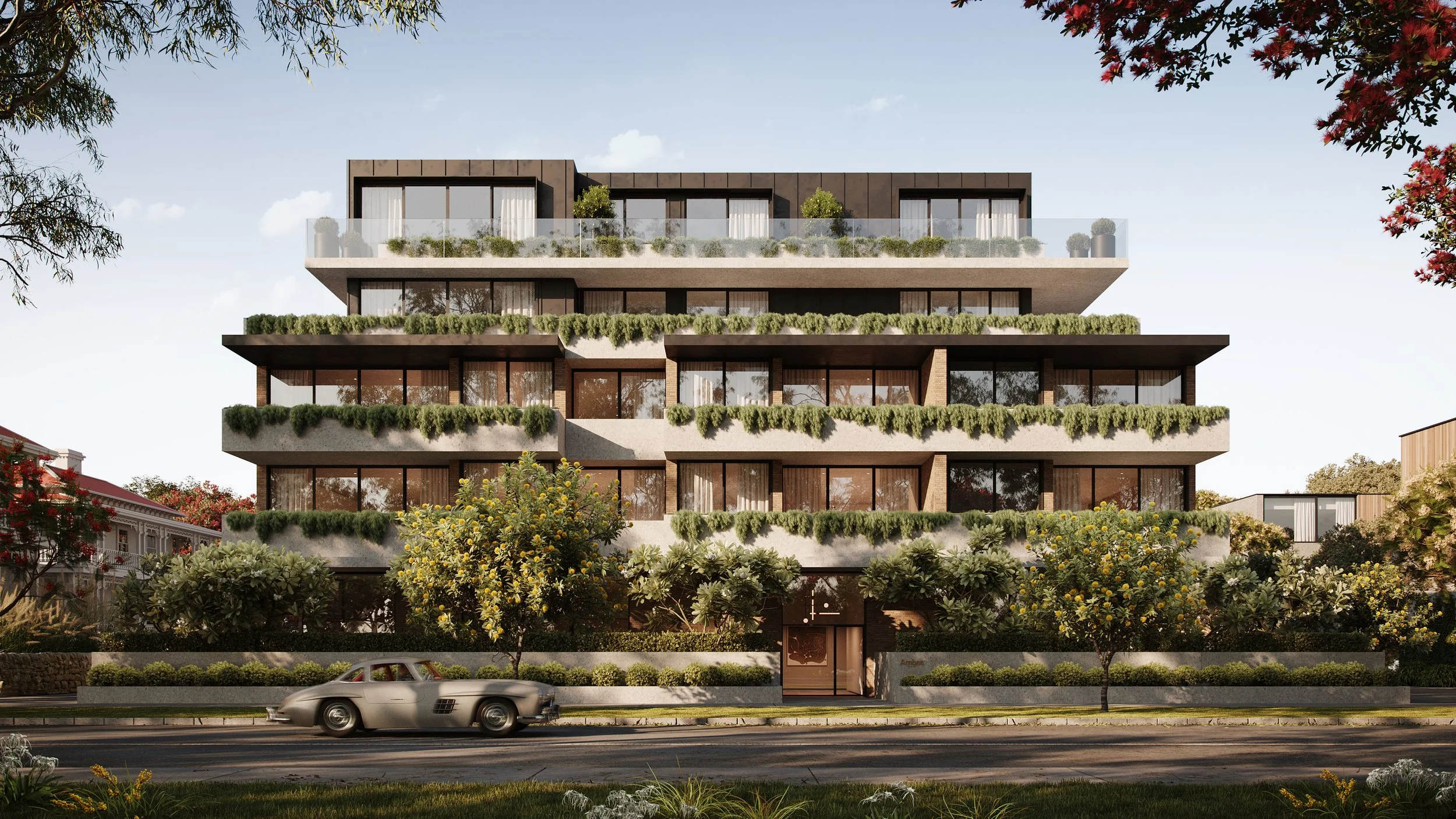 A modern multi-story building with large glass windows and extensive greenery on each floor's balcony, situated on a street with trees, flowers, and a passing silver sports car.