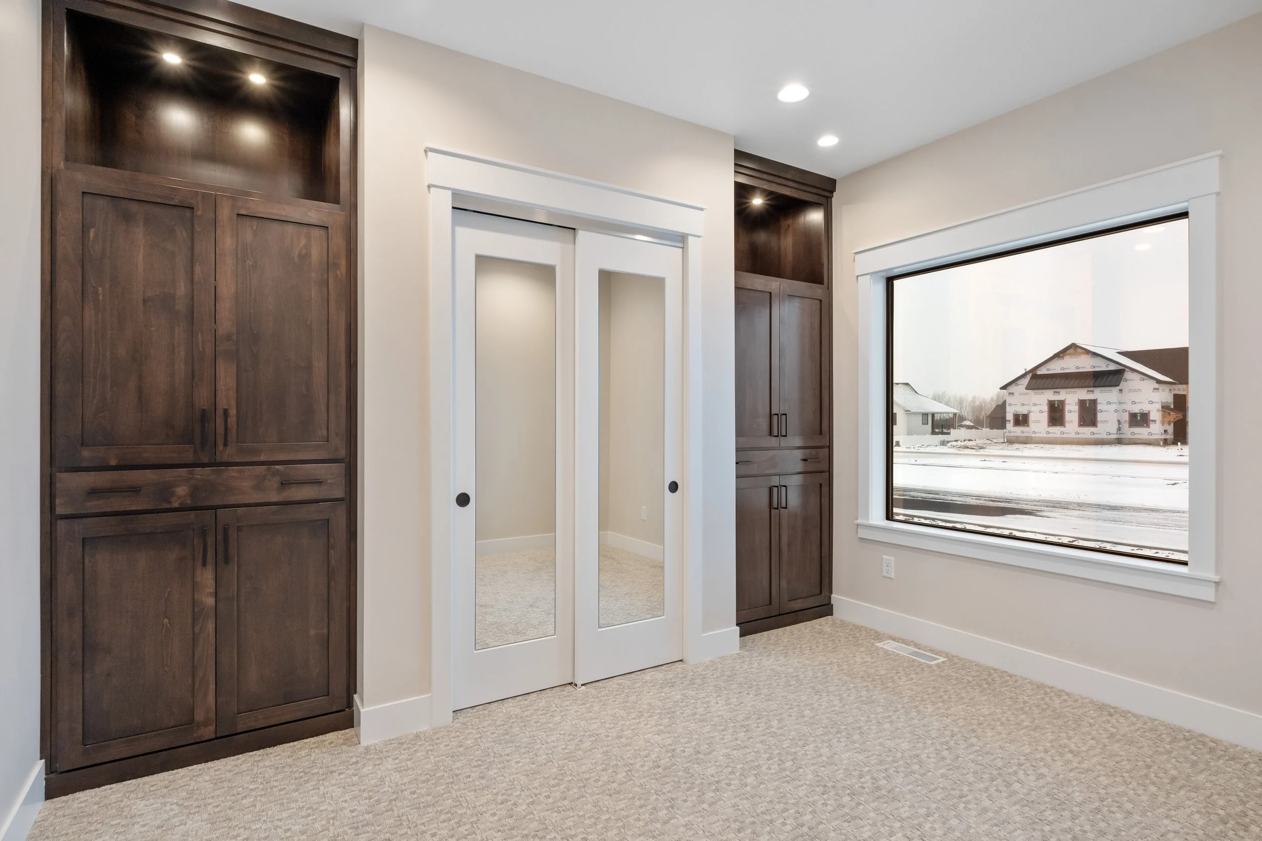 Entryway with white double doors and dark wood accents — JAB Construction’s Timeless Craftsman custom home in Iona, Idaho.