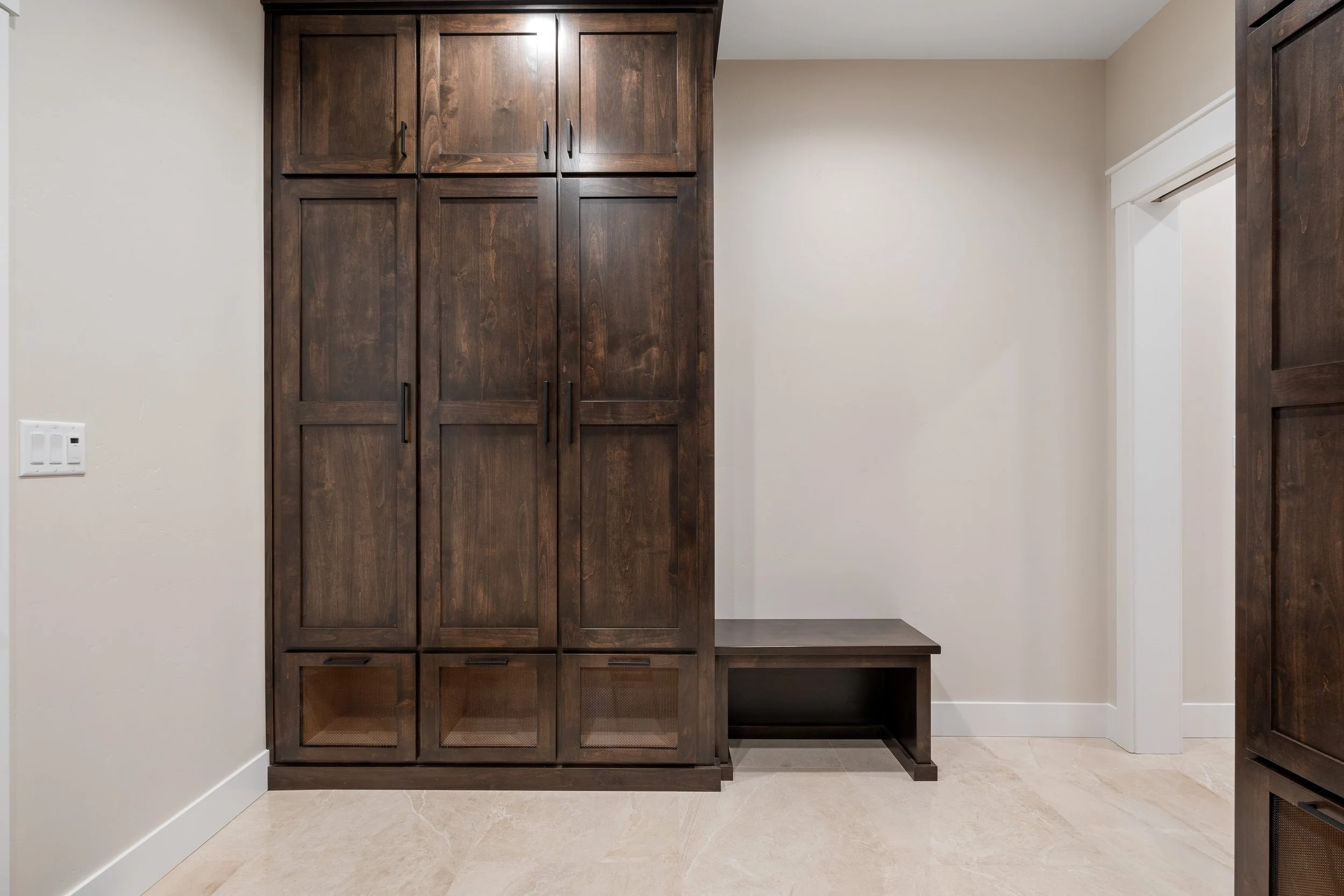Entry storage cabinet with a built-in bench — JAB Construction’s Timeless Craftsman custom home in Iona, Idaho.