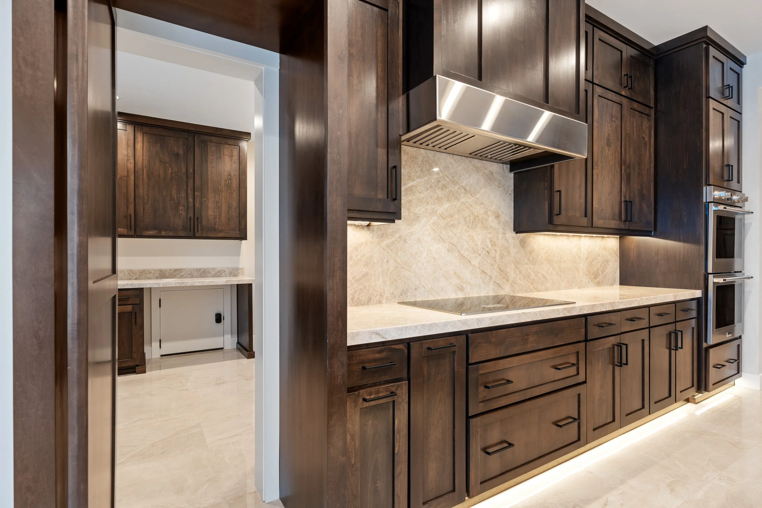 Kitchen range hood above dark cabinetry — JAB Construction’s Timeless Craftsman custom home in Iona, Idaho.