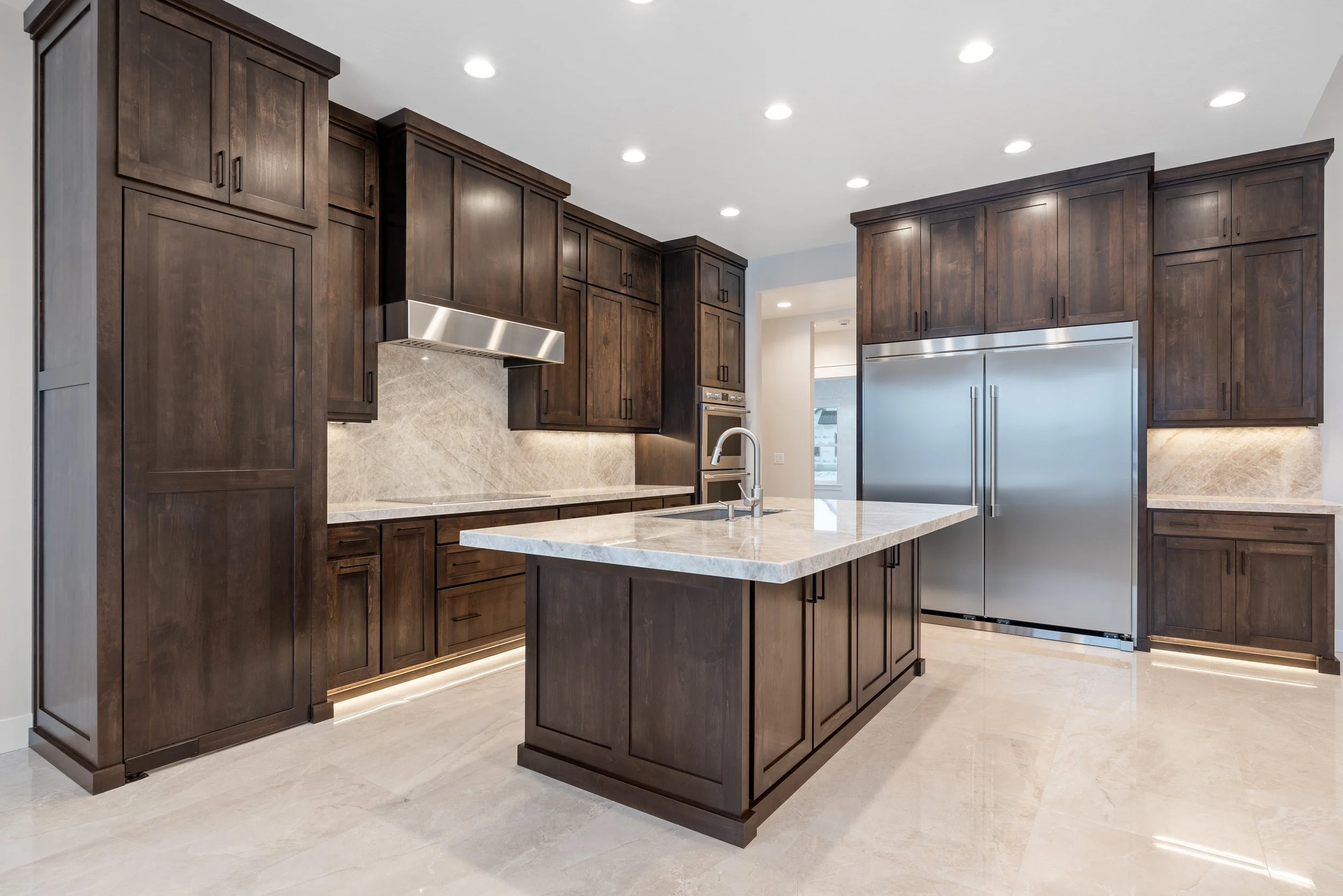 Kitchen island with light countertops and pendant lighting — JAB Construction’s Timeless Craftsman custom home in Iona, Idaho.