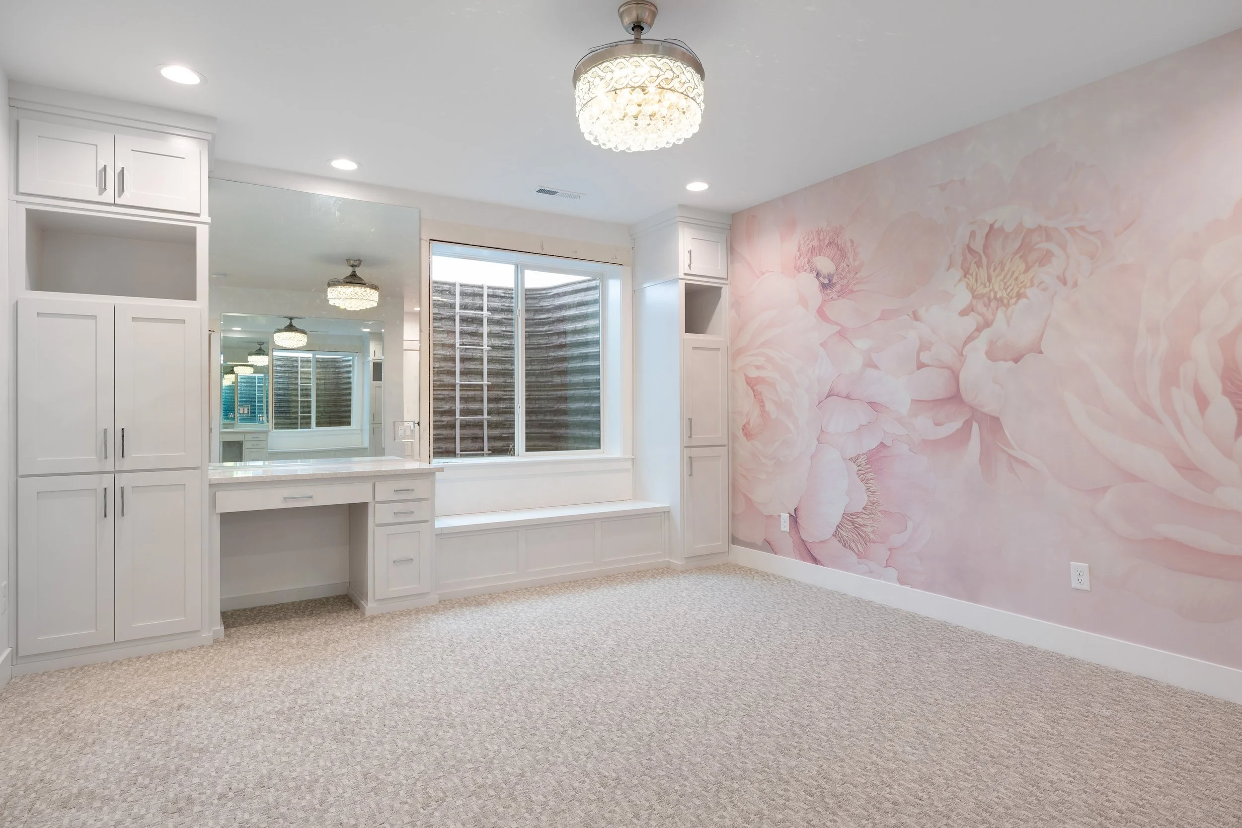 Bedroom with a patterned accent wall and built-in desk — JAB Construction’s Timeless Craftsman custom home in Iona, Idaho.