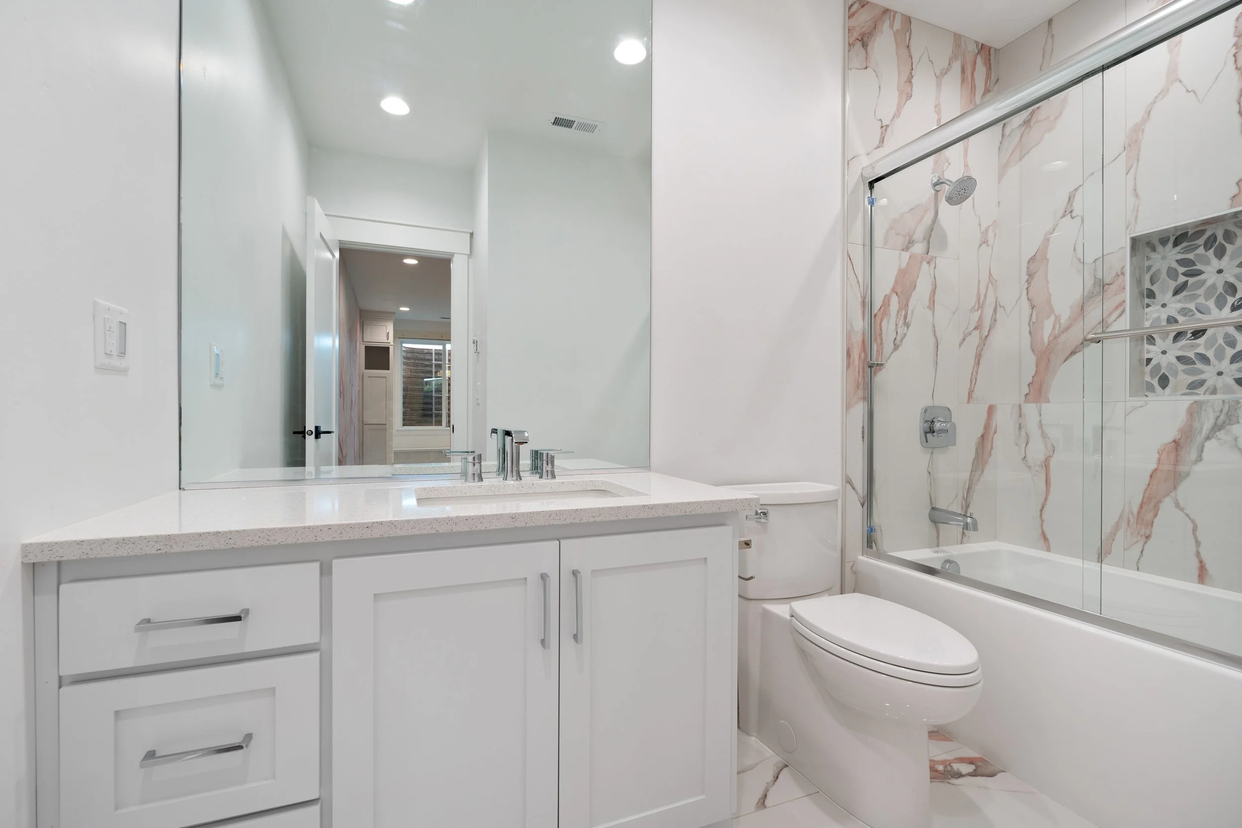 Bathroom with a white vanity, mirror and toilet — JAB Construction’s Timeless Craftsman custom home in Iona, Idaho.