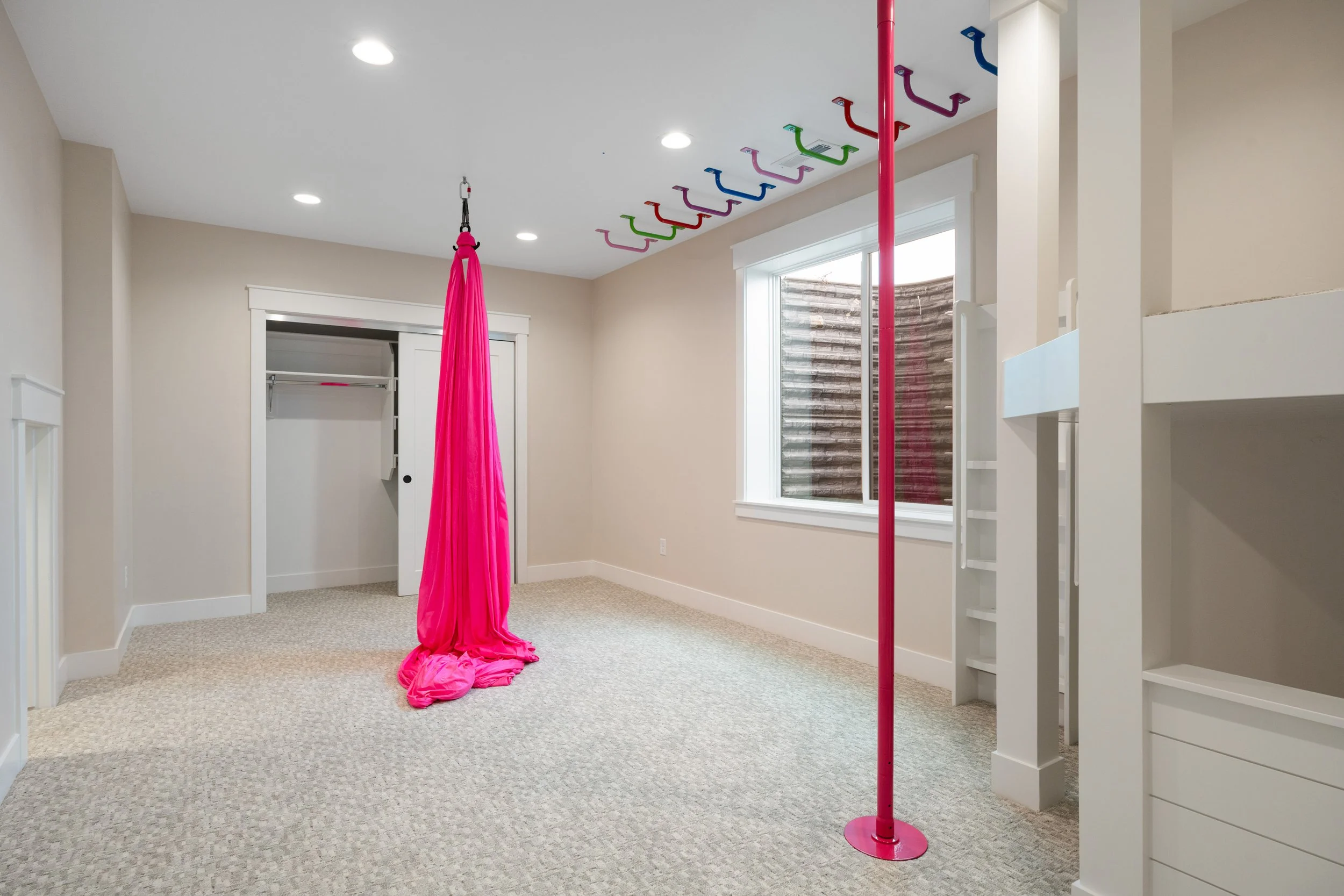 Indoor play area with hanging fabric swings — JAB Construction’s Timeless Craftsman custom home in Iona, Idaho.