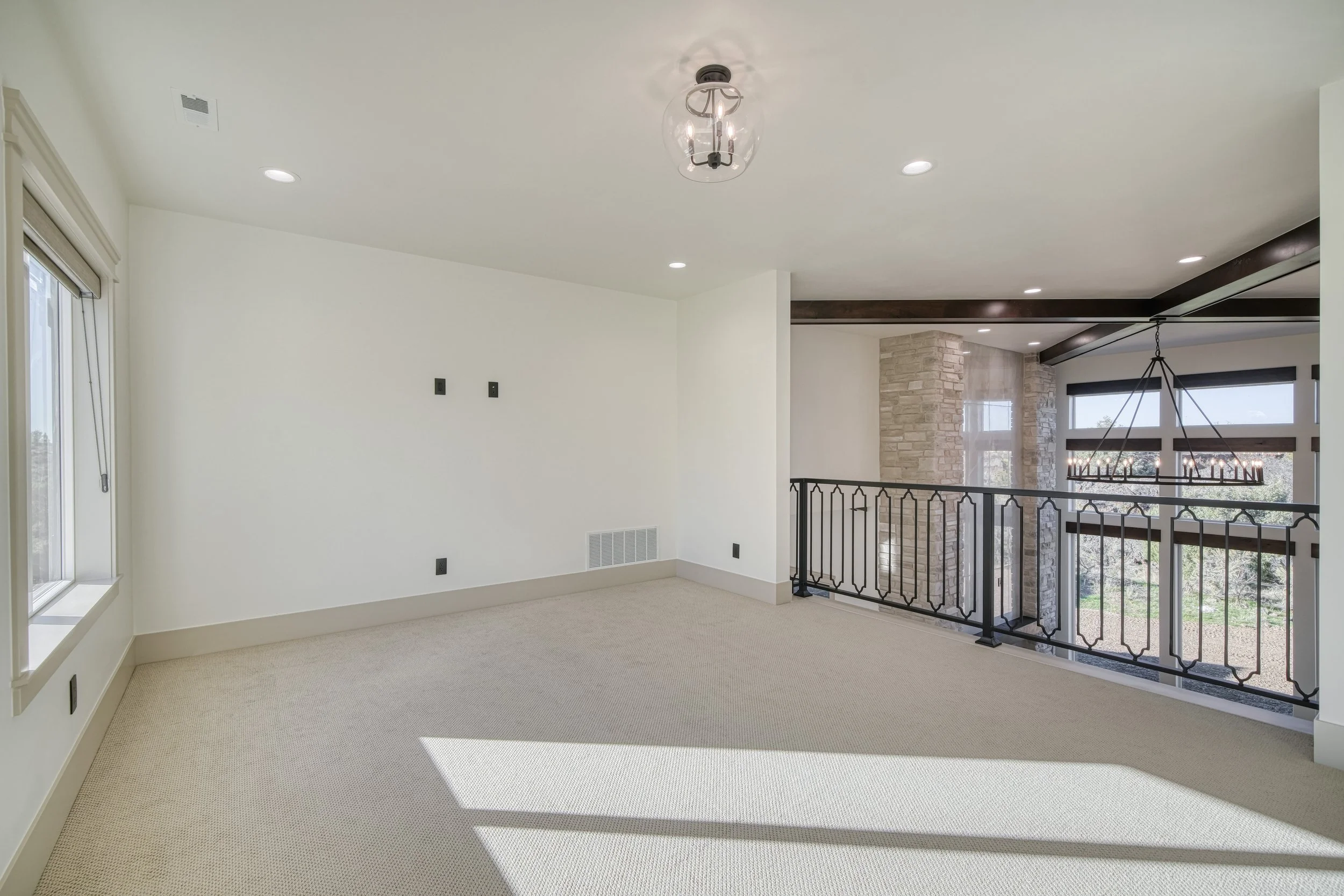 Carpeted upper room beside an open railing — JAB Construction’s Modern Transitional custom home in Blackfoot, Idaho.