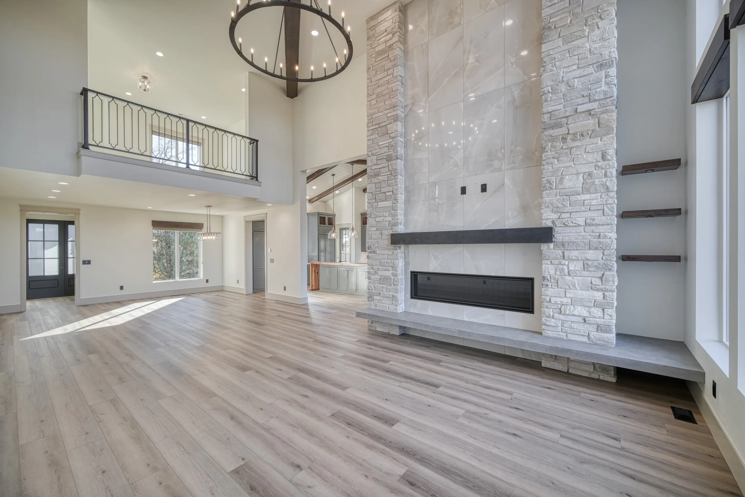 Close view of the tall stone fireplace surround — JAB Construction’s Modern Transitional custom home in Blackfoot, Idaho.