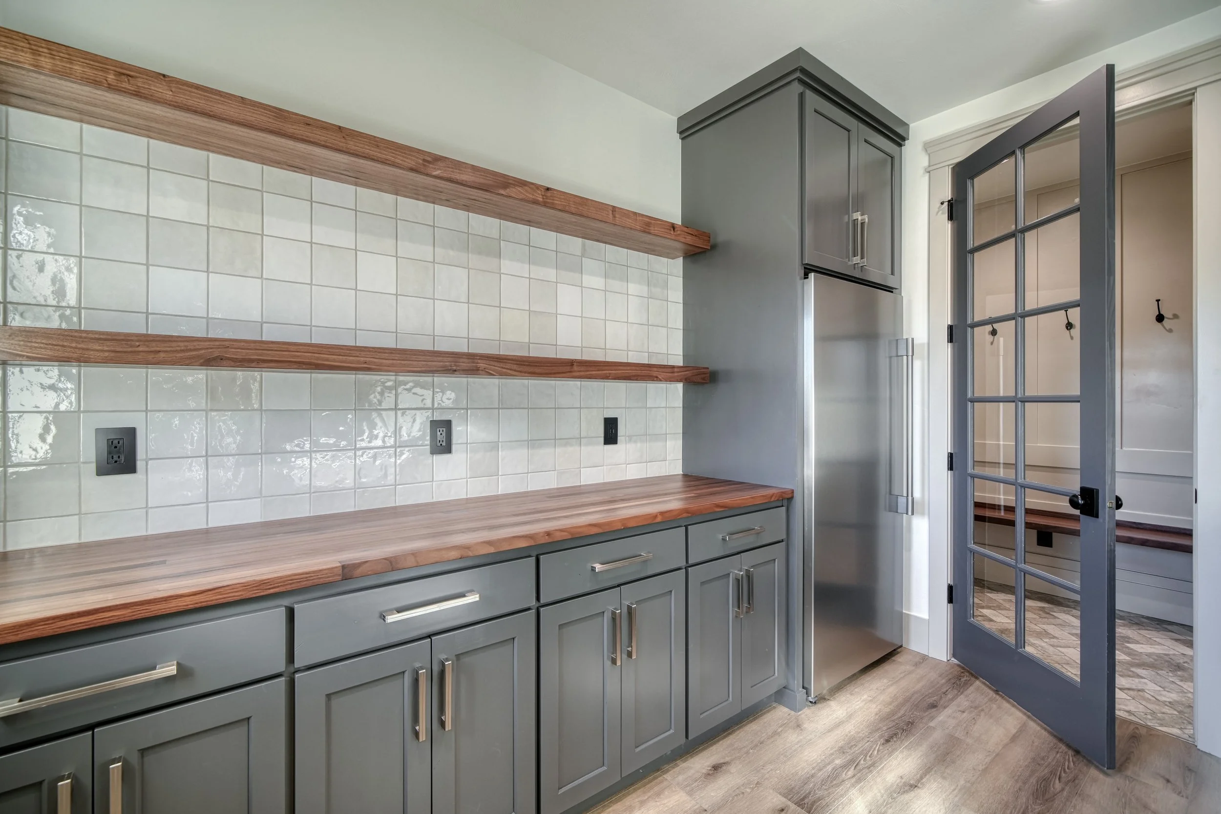 Pantry counter with floating wood shelves — JAB Construction’s Modern Transitional custom home in Blackfoot, Idaho.