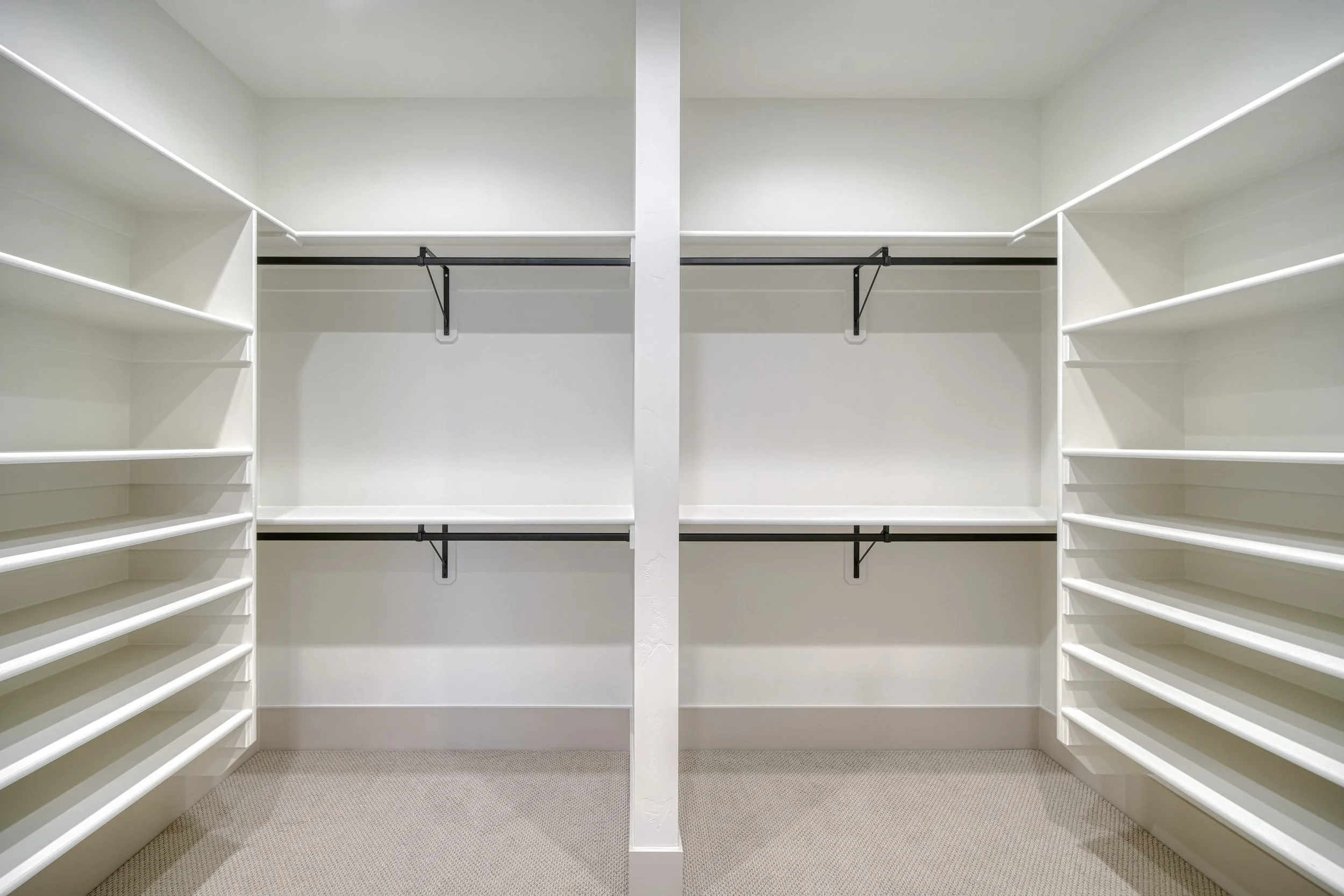 Walk-in closet with shelves and clothes rails — JAB Construction’s Modern Transitional custom home in Blackfoot, Idaho.