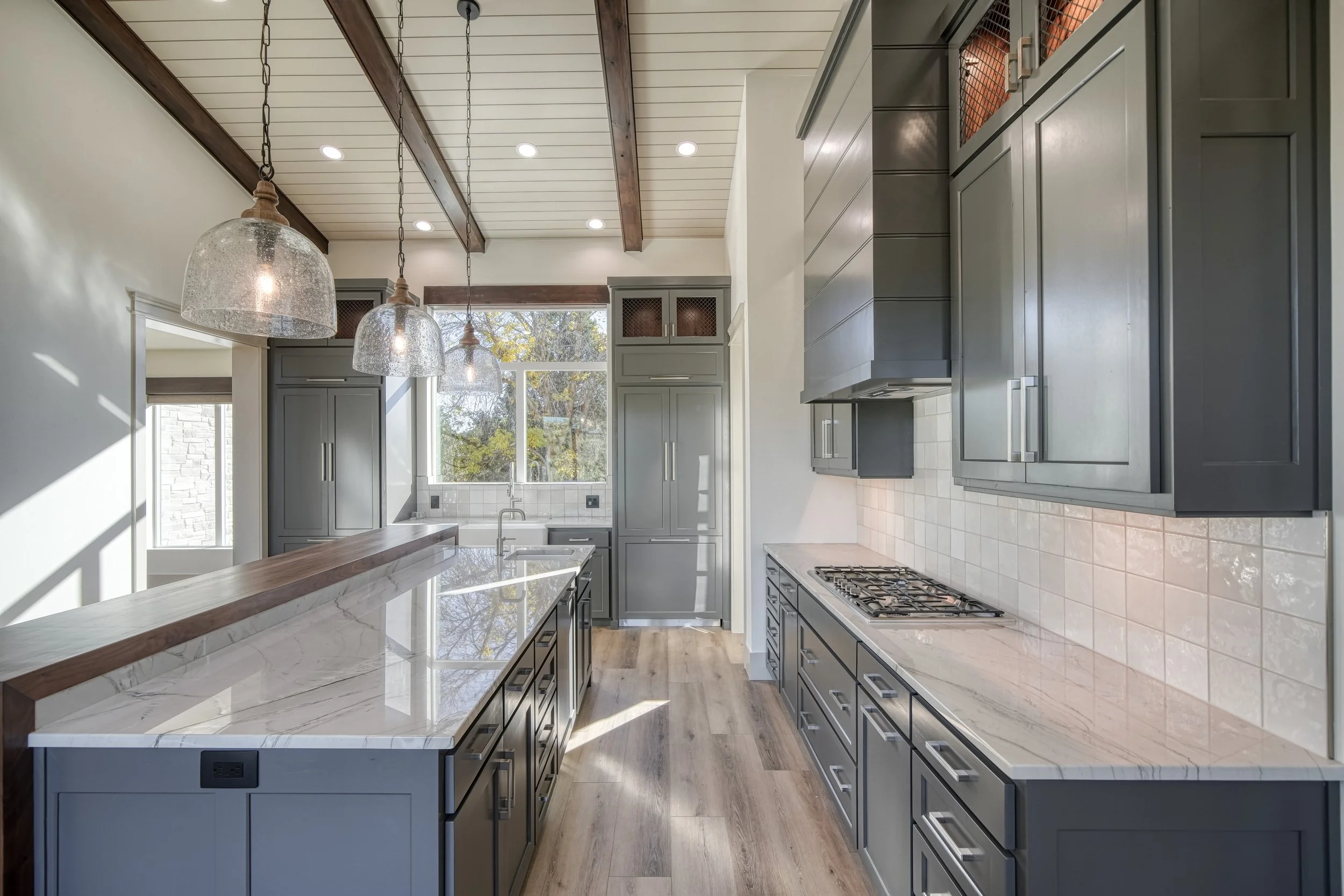 Kitchen workspace with light countertops and dark cabinets — JAB Construction’s Modern Transitional custom home in Blackfoot, Idaho.