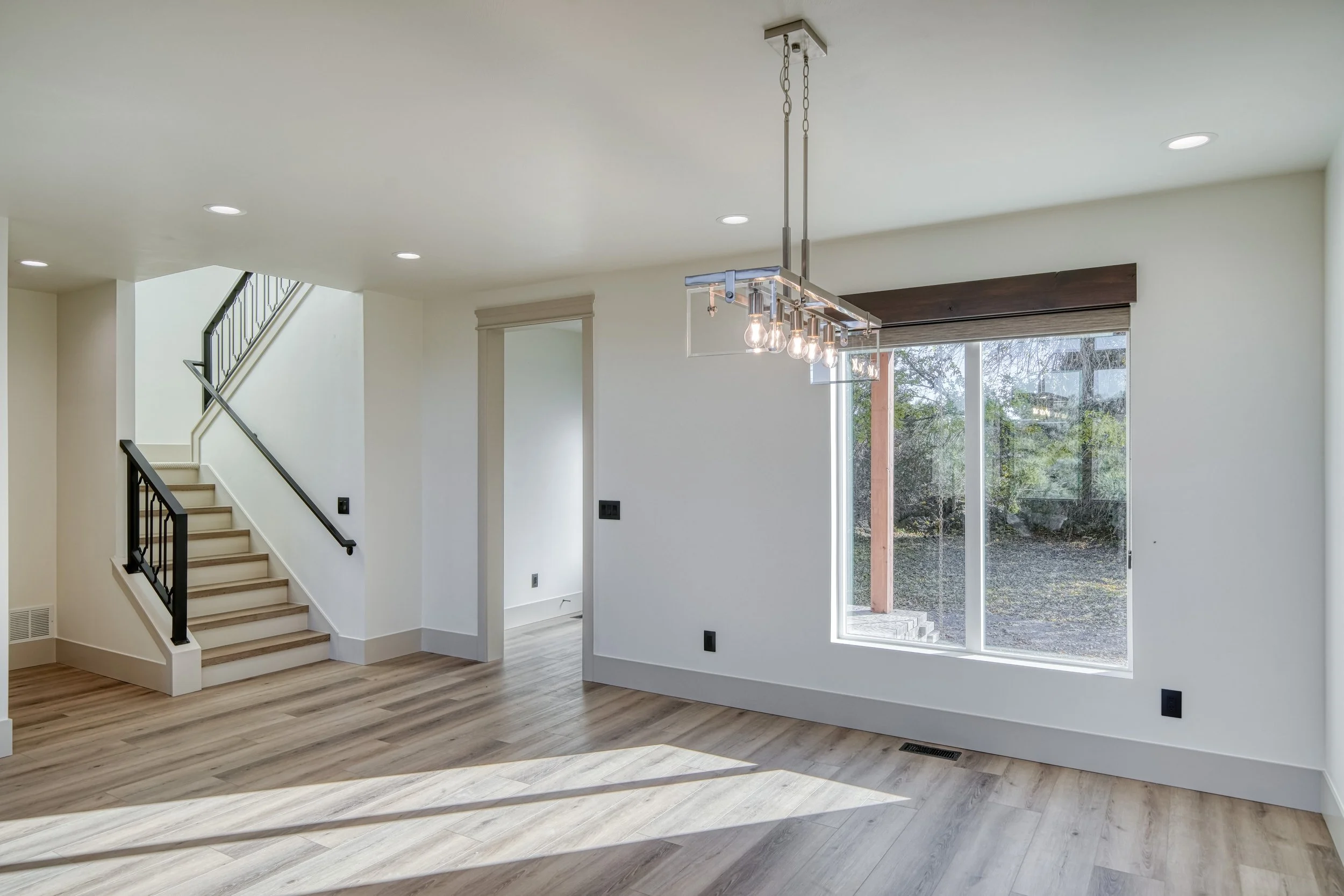 Entry area with a front door and large windows — JAB Construction’s Modern Transitional custom home in Blackfoot, Idaho.