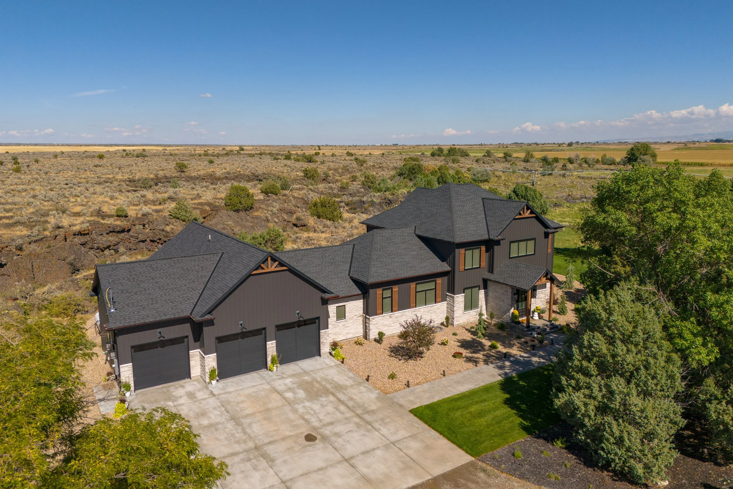 Aerial view of the home, garage and surrounding grounds — JAB Construction’s Modern Transitional custom home in Blackfoot, Idaho.