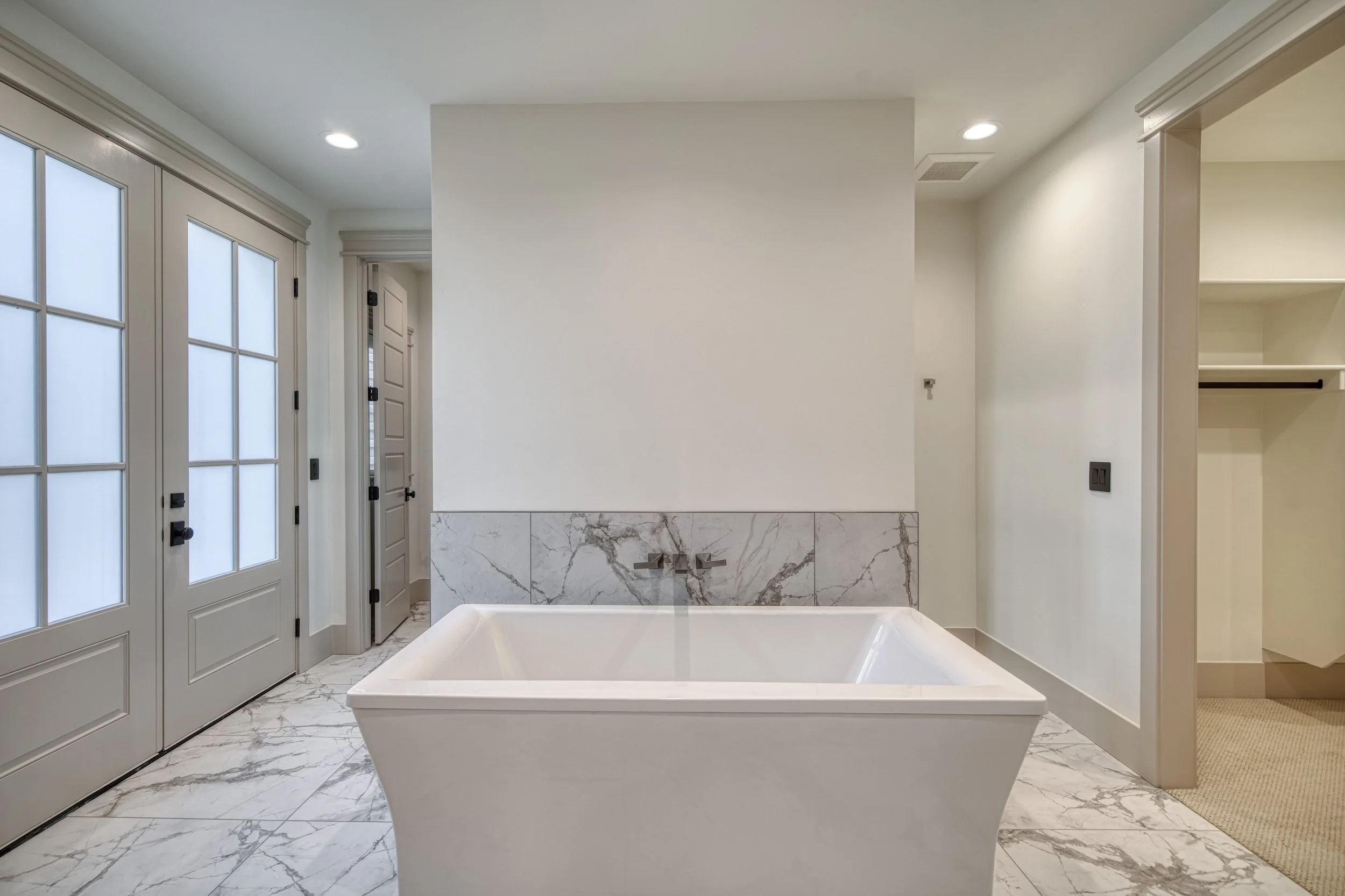 Freestanding tub with a patterned tile surround — JAB Construction’s Modern Transitional custom home in Blackfoot, Idaho.