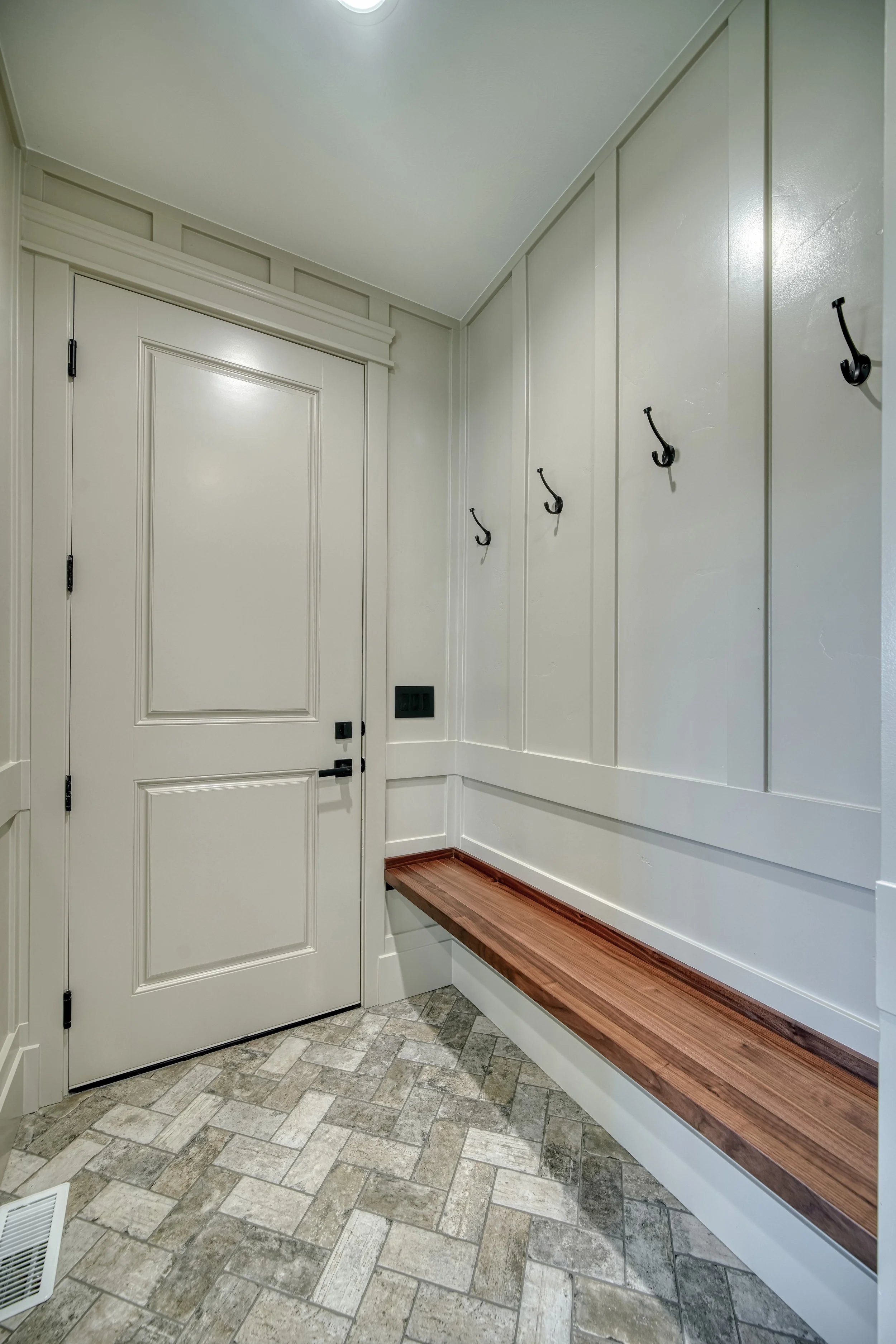Mudroom bench with storage cabinets and coat hooks — JAB Construction’s Modern Transitional custom home in Blackfoot, Idaho.