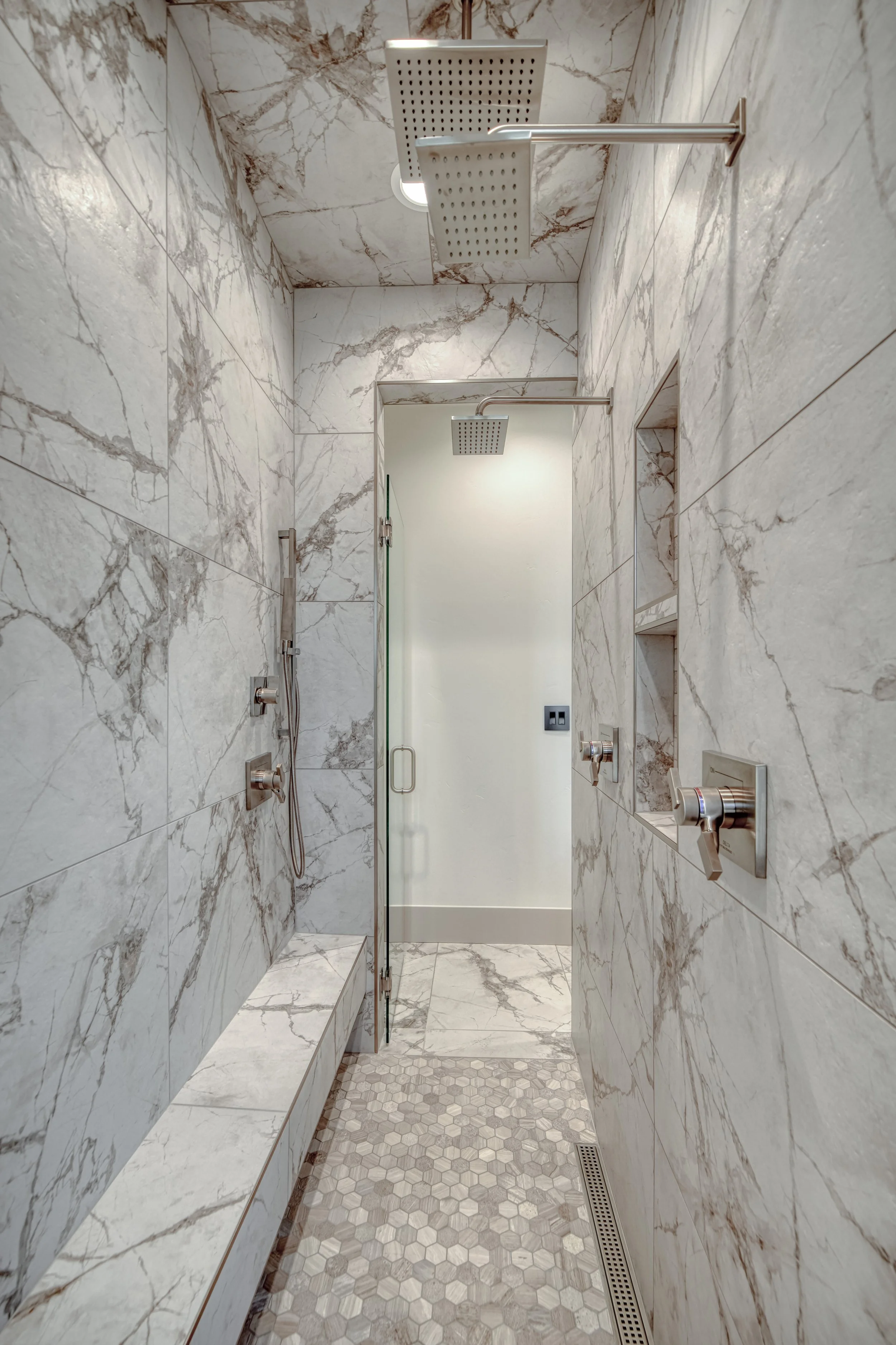 Tiled walk-in shower with built-in shelving — JAB Construction’s Modern Transitional custom home in Blackfoot, Idaho.