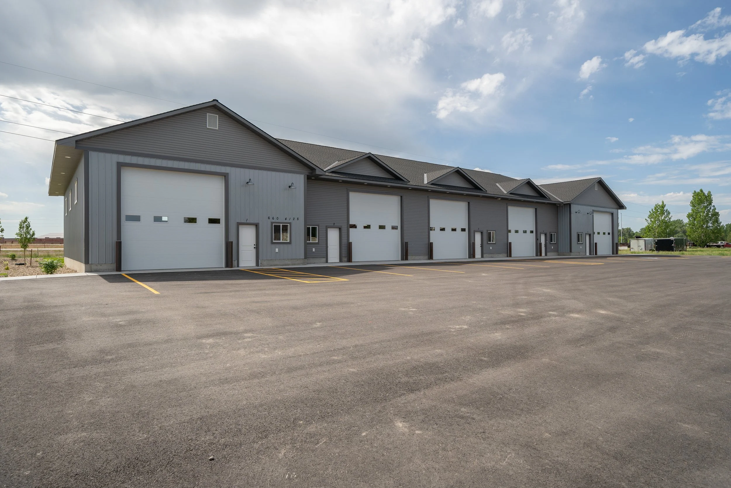 Angled view of commercial garage units and parking area — JAB Construction’s Commercial Lease Space project in Rigby, Idaho.