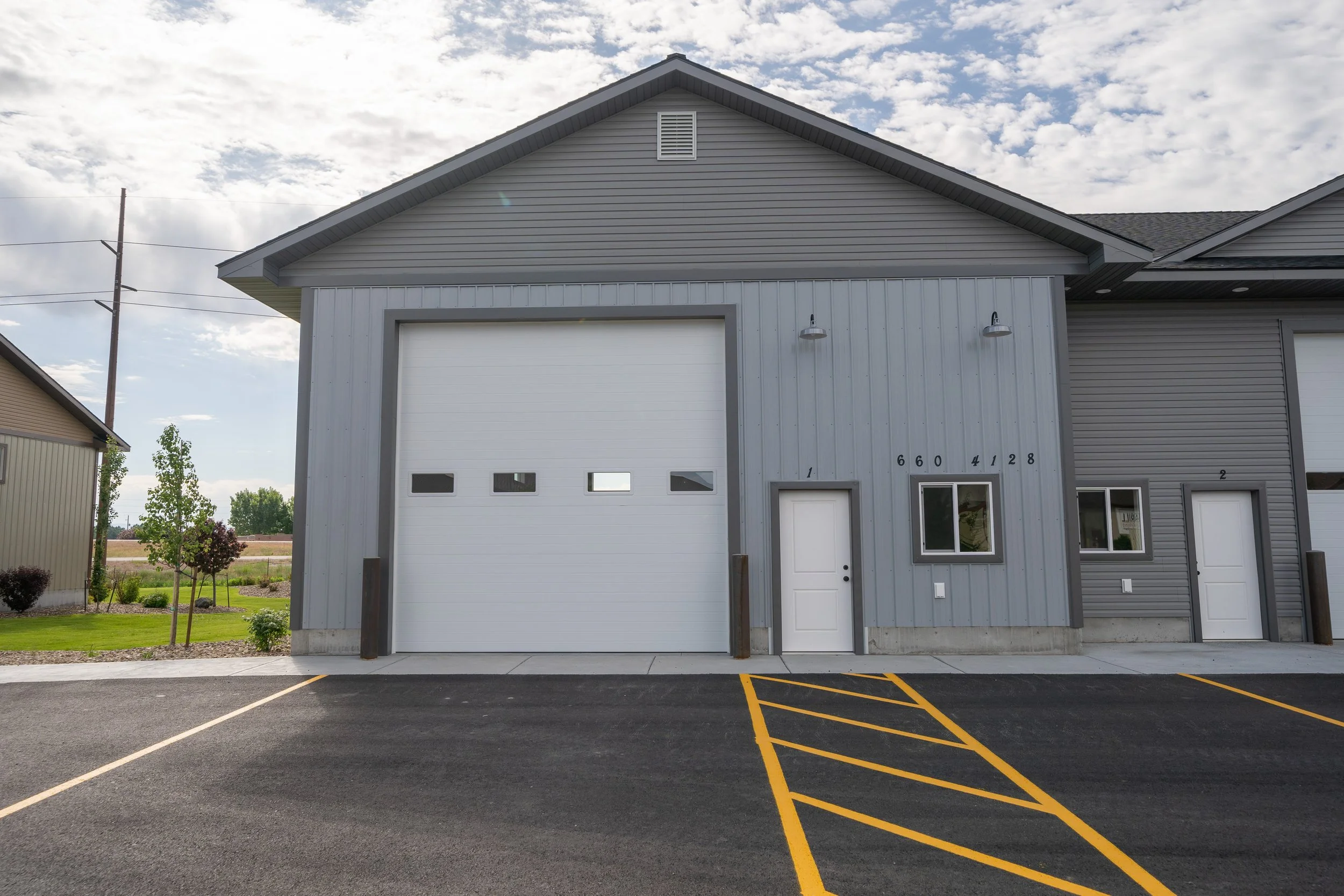 Commercial unit with an overhead garage door and side entrance — JAB Construction’s Commercial Lease Space project in Rigby, Idaho.