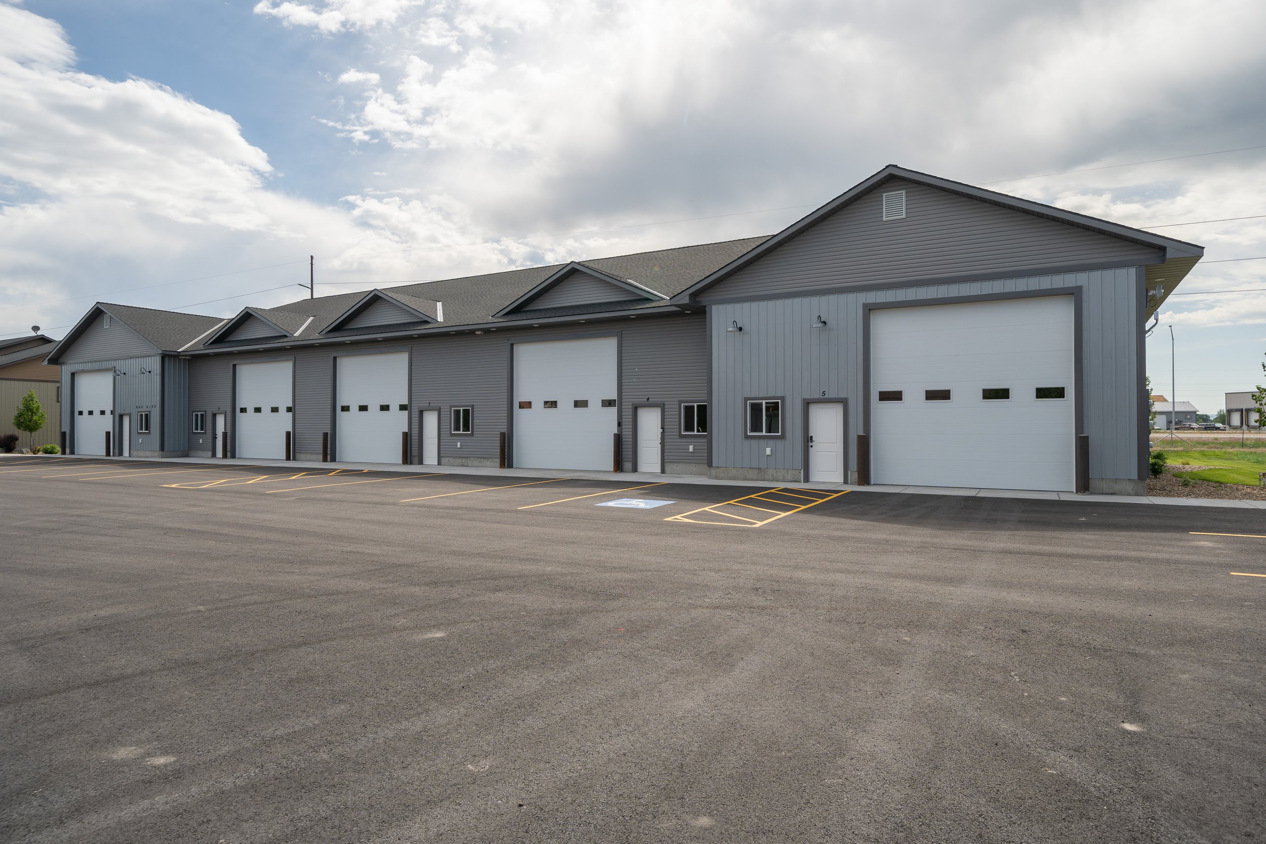 Commercial building facade with gabled rooflines and garage doors — JAB Construction’s Commercial Lease Space project in Rigby, Idaho.