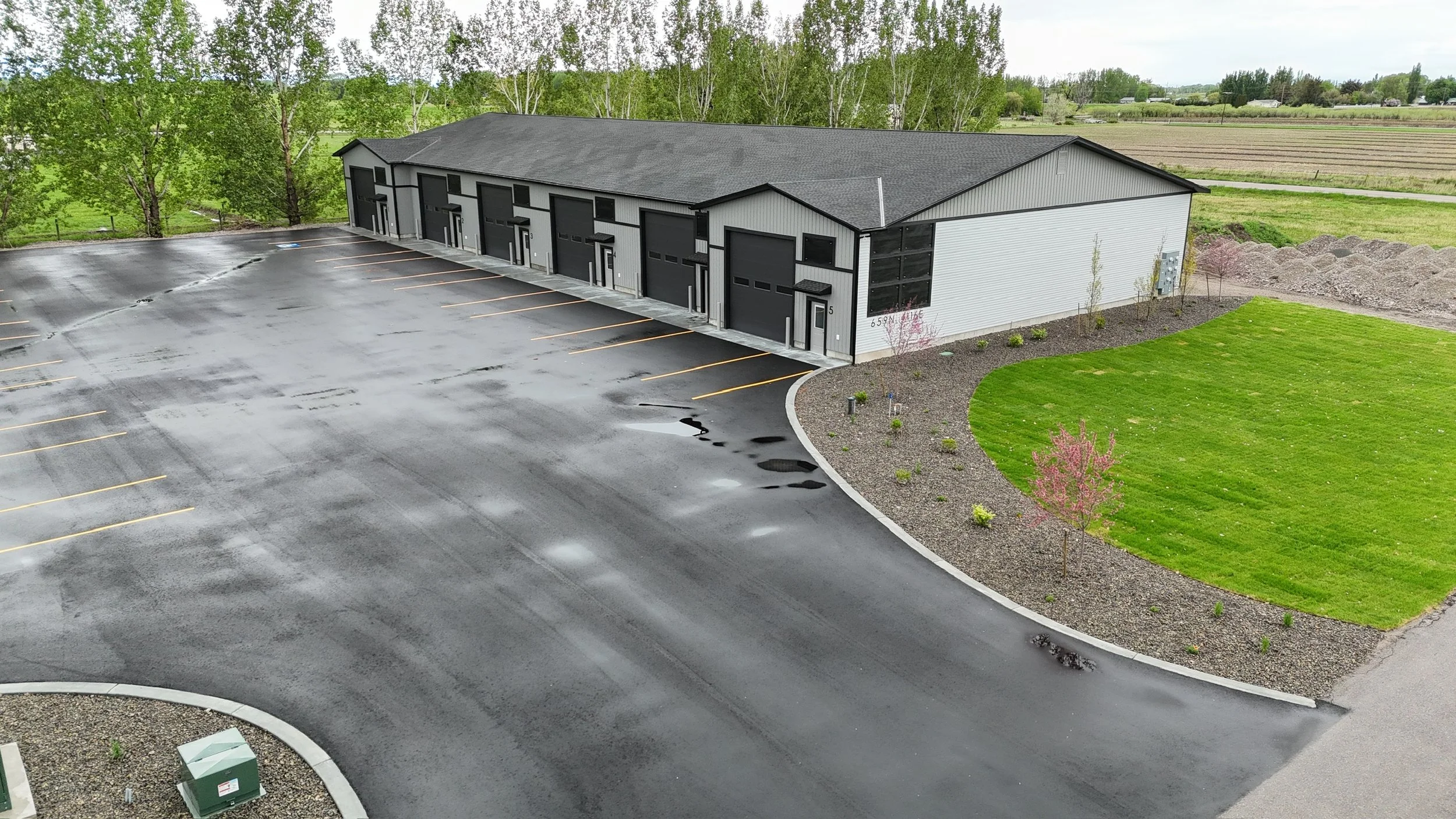 Angled aerial view of commercial units and paved parking — JAB Construction’s Modern Commercial Lease Space project in Rigby, Idaho.