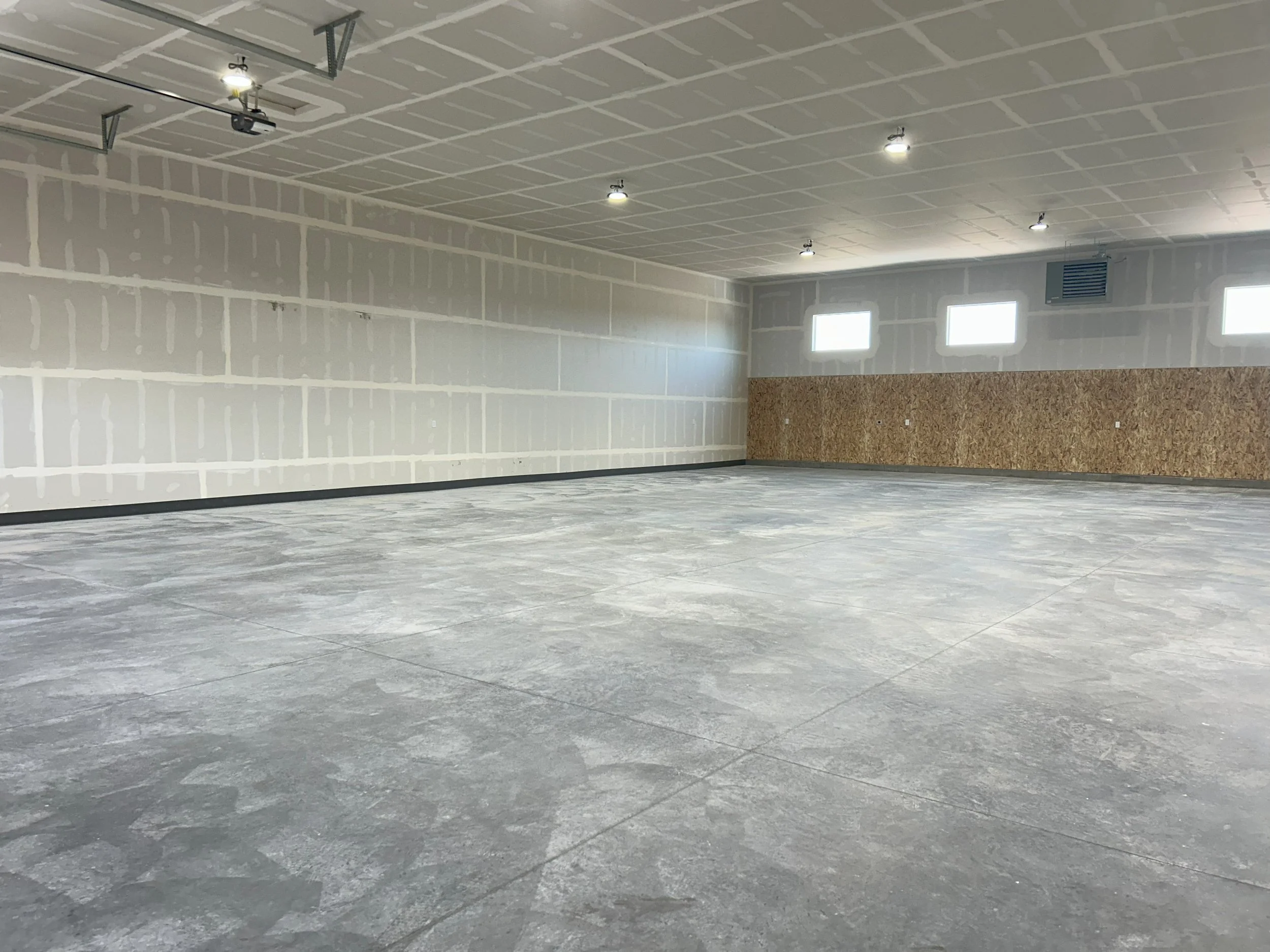 Open commercial interior with concrete flooring and light walls — JAB Construction’s Modern Commercial Lease Space project in Rigby, Idaho.