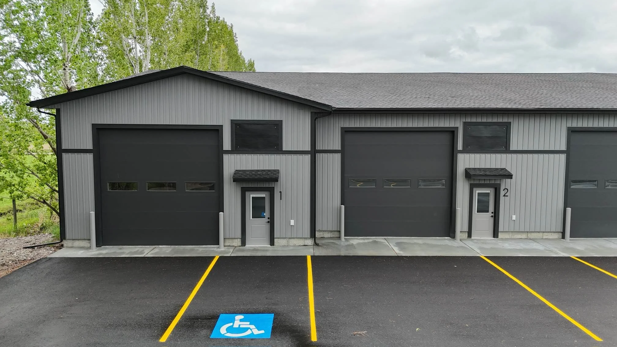 Commercial unit entrance beside an overhead door and accessible parking — JAB Construction’s Modern Commercial Lease Space project in Rigby, Idaho.