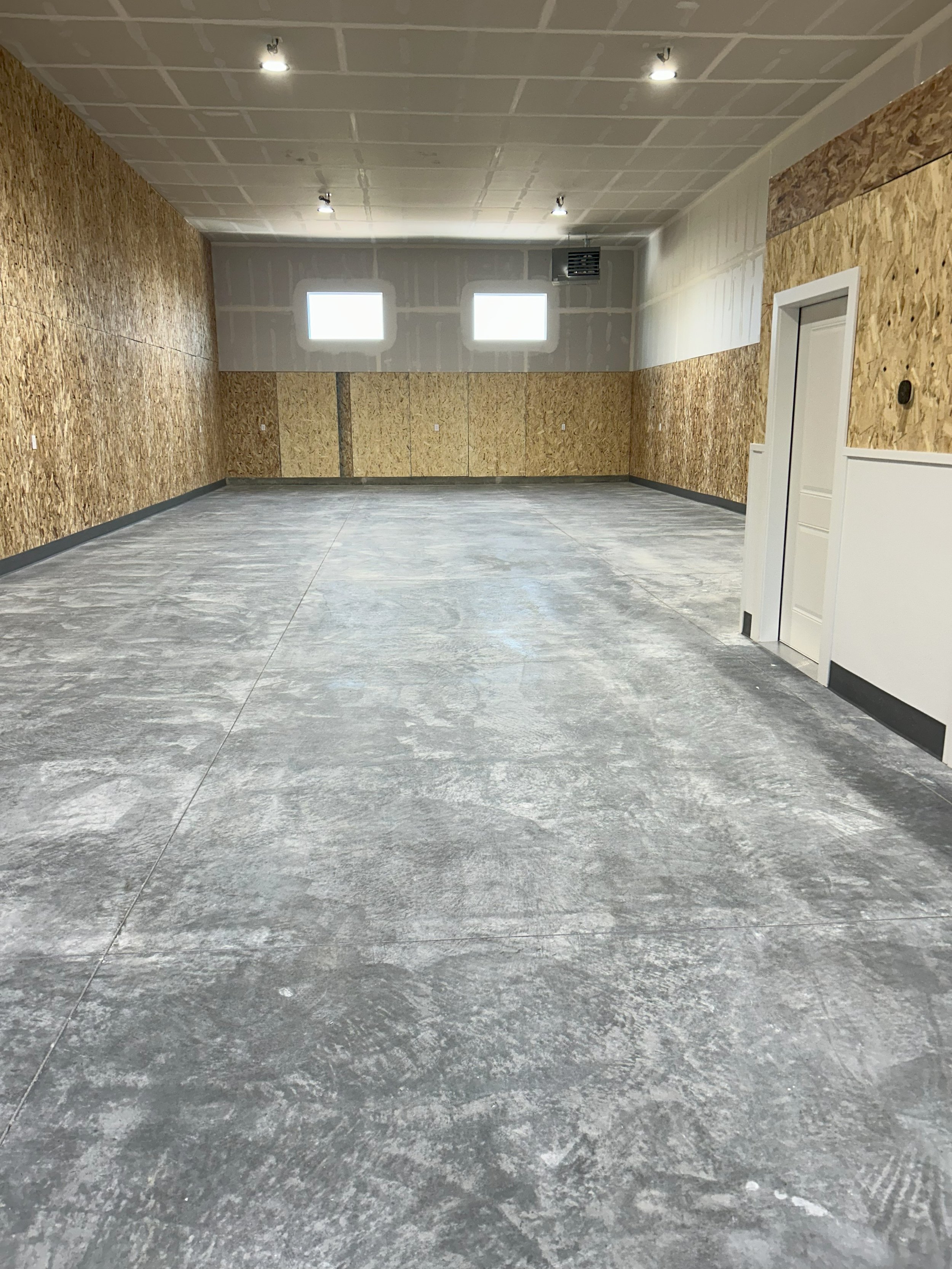 Commercial unit interior with an entry door and windows — JAB Construction’s Modern Commercial Lease Space project in Rigby, Idaho.