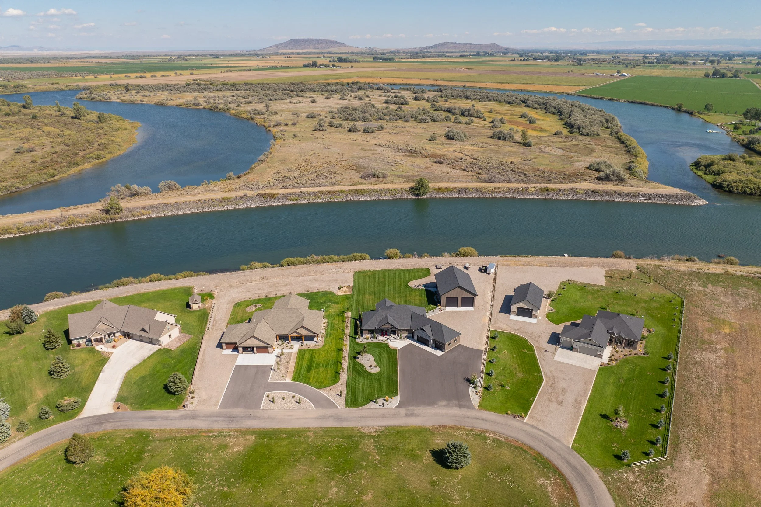 Aerial view of the home near a river — JAB Construction’s Stone Craftsman custom home in Roberts, Idaho.