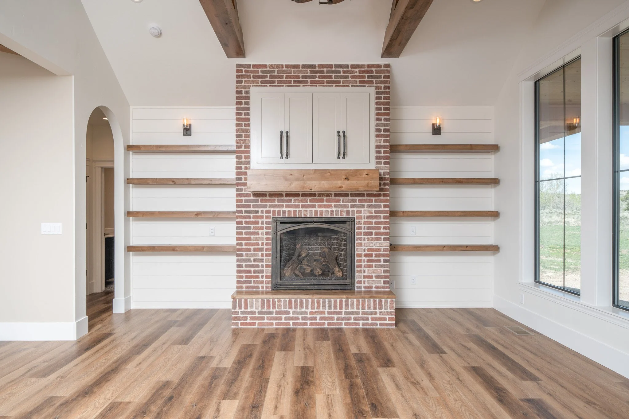 Brick fireplace flanked by built-in shelving — JAB Construction’s Modern Rustic custom home in Idaho Falls, Idaho.