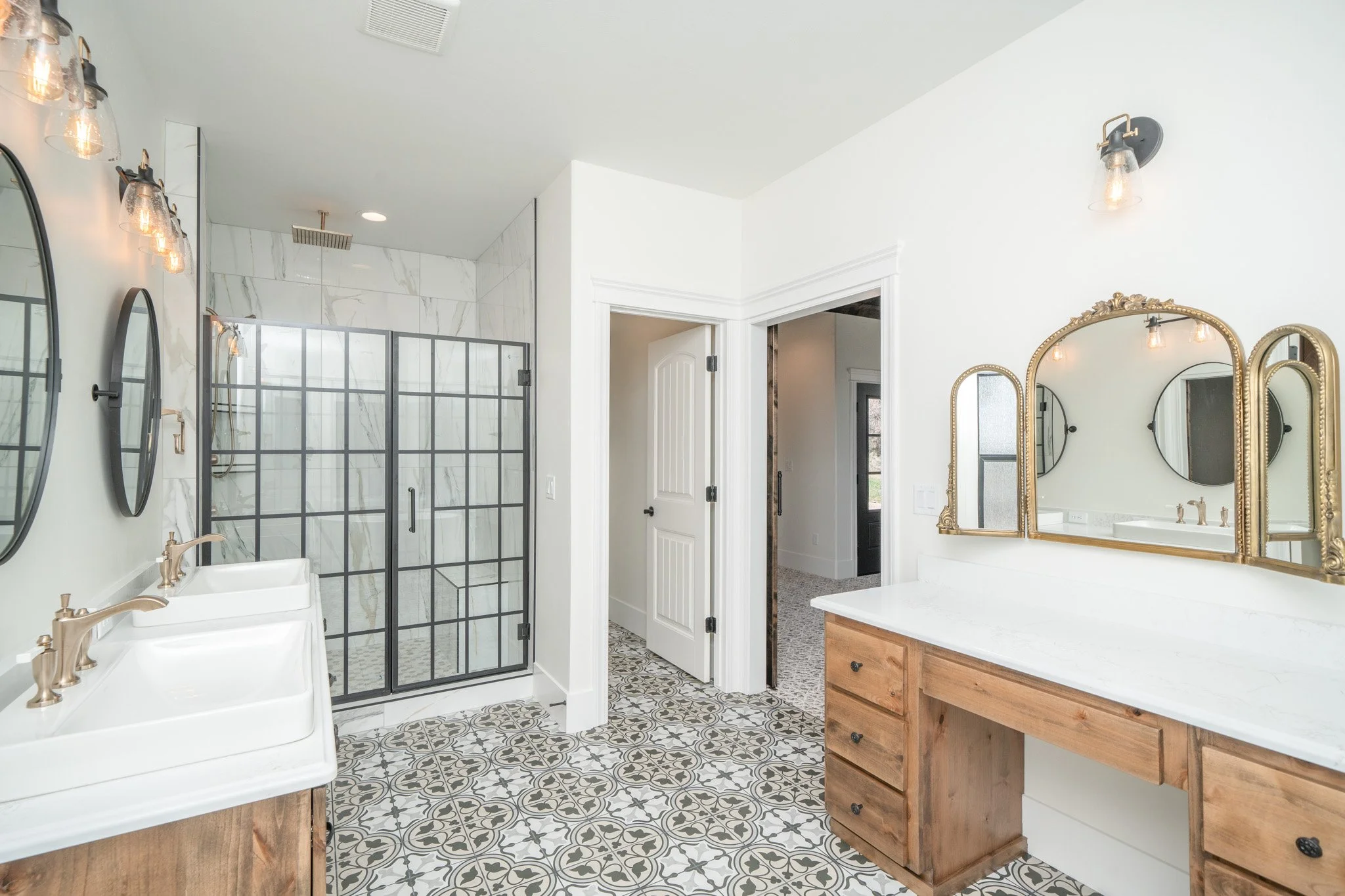 Bathroom with wood cabinetry and a glass-enclosed shower — JAB Construction’s Modern Rustic custom home in Idaho Falls, Idaho.