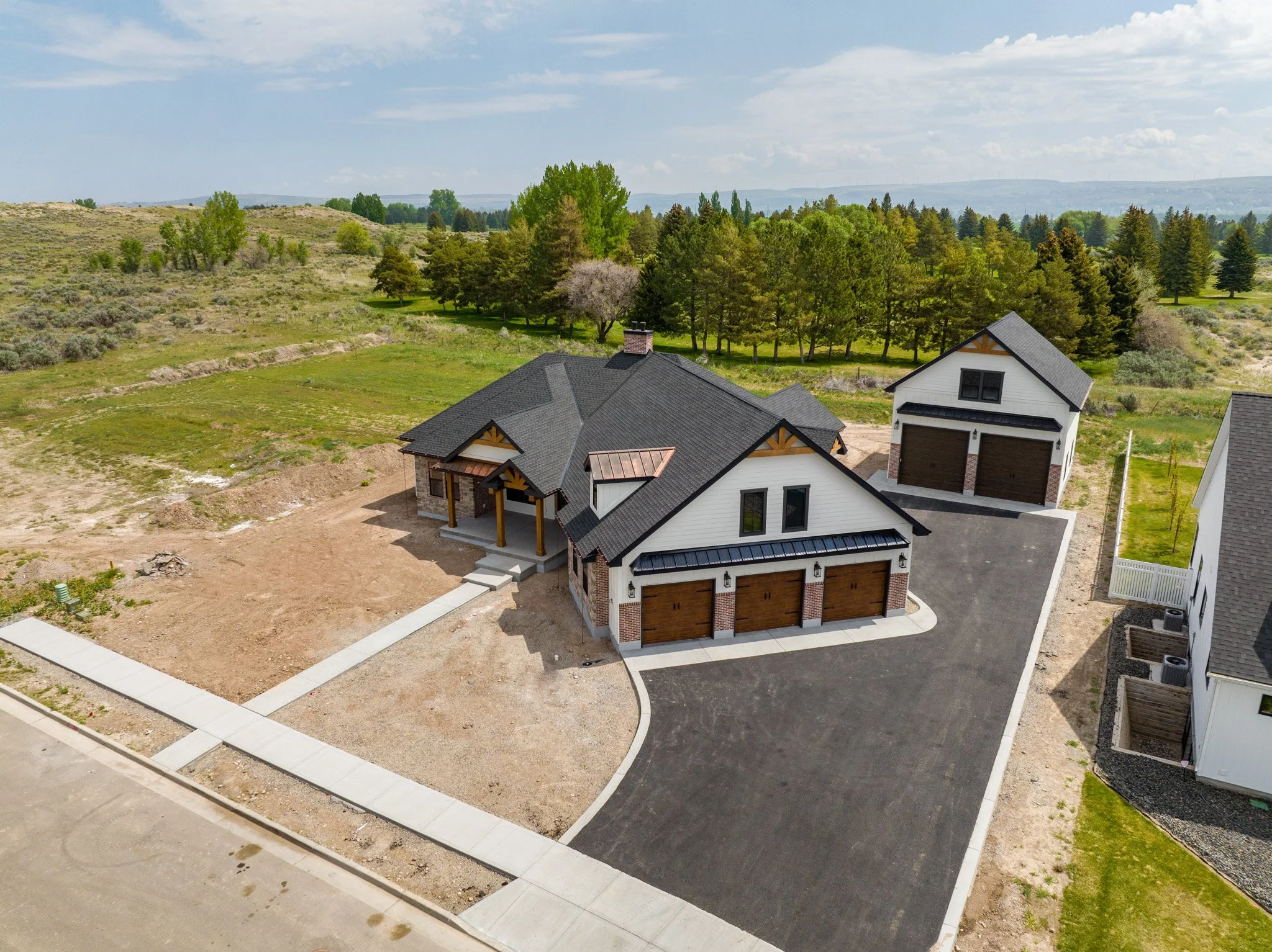 Aerial view of the home, garage and surrounding property — JAB Construction’s Modern Rustic custom home in Idaho Falls, Idaho.