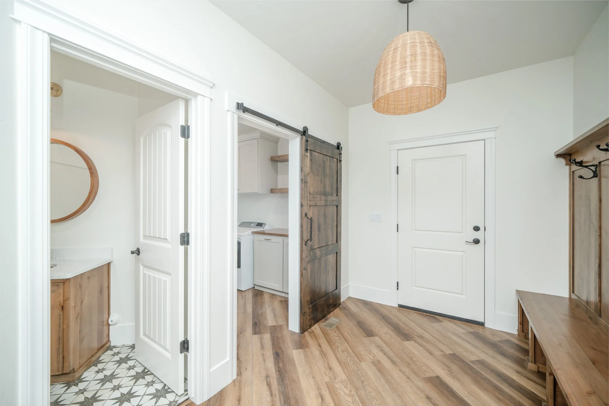 Entry storage area with white cabinetry and a pendant light — JAB Construction’s Modern Rustic custom home in Idaho Falls, Idaho.