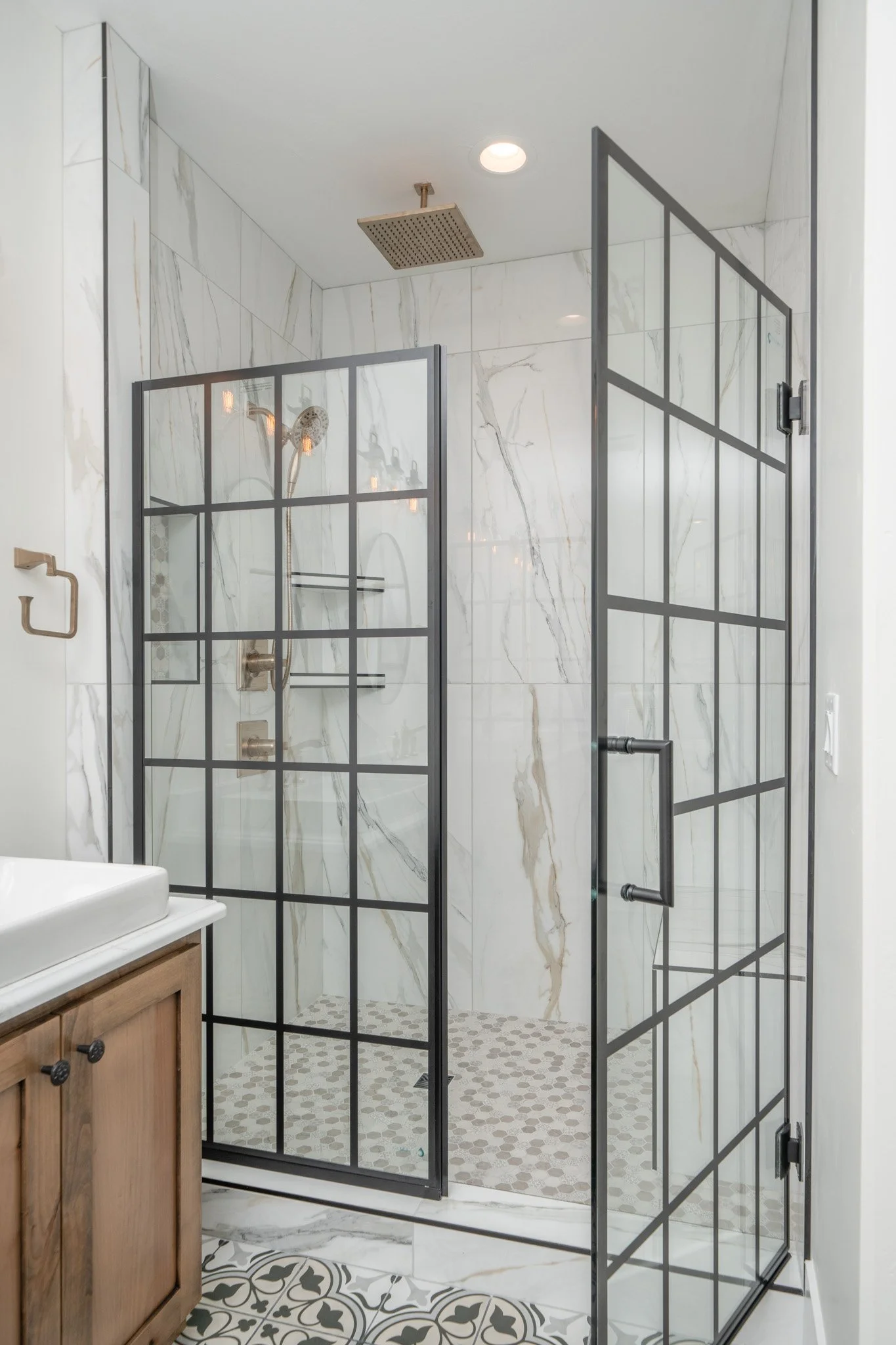 Glass-enclosed shower with dark-framed doors — JAB Construction’s Modern Rustic custom home in Idaho Falls, Idaho.
