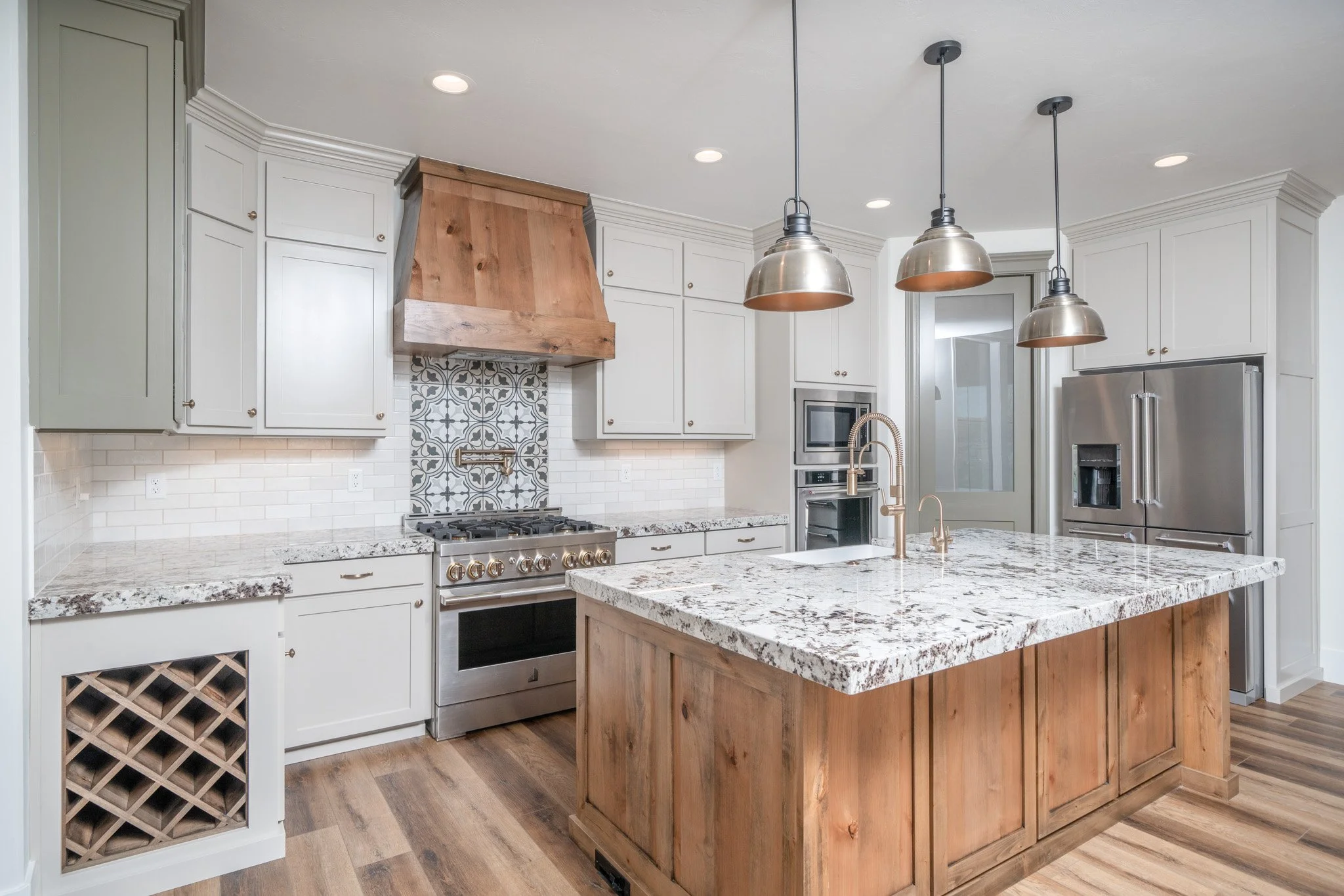 Kitchen with wood and white cabinets and a large island — JAB Construction’s Modern Rustic custom home in Idaho Falls, Idaho.