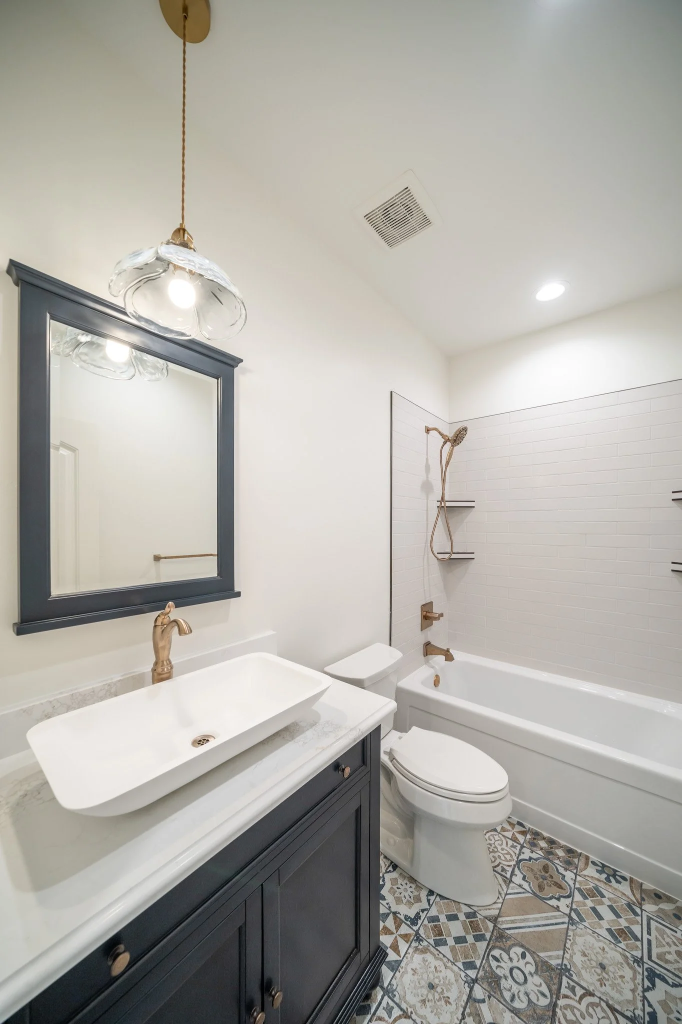 Bathroom with a white vanity, mirror and tub — JAB Construction’s Modern Rustic custom home in Idaho Falls, Idaho.