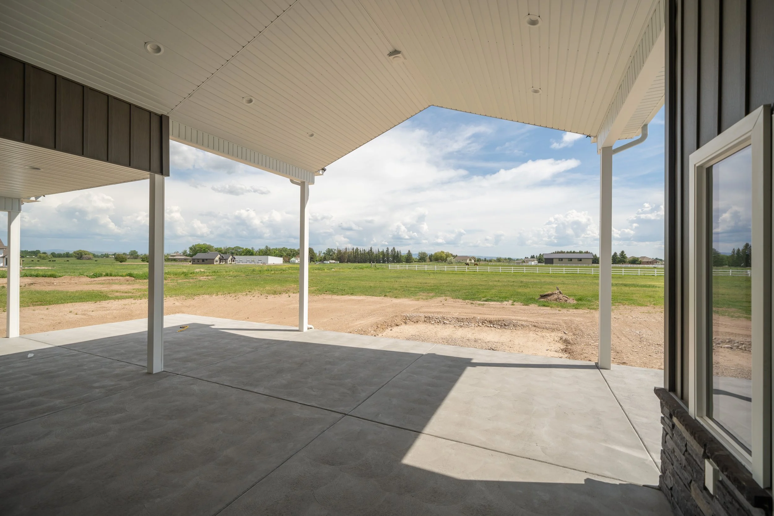 Covered patio overlooking open fields — JAB Construction’s Modern Craftsman custom home in Idaho Falls, Idaho.