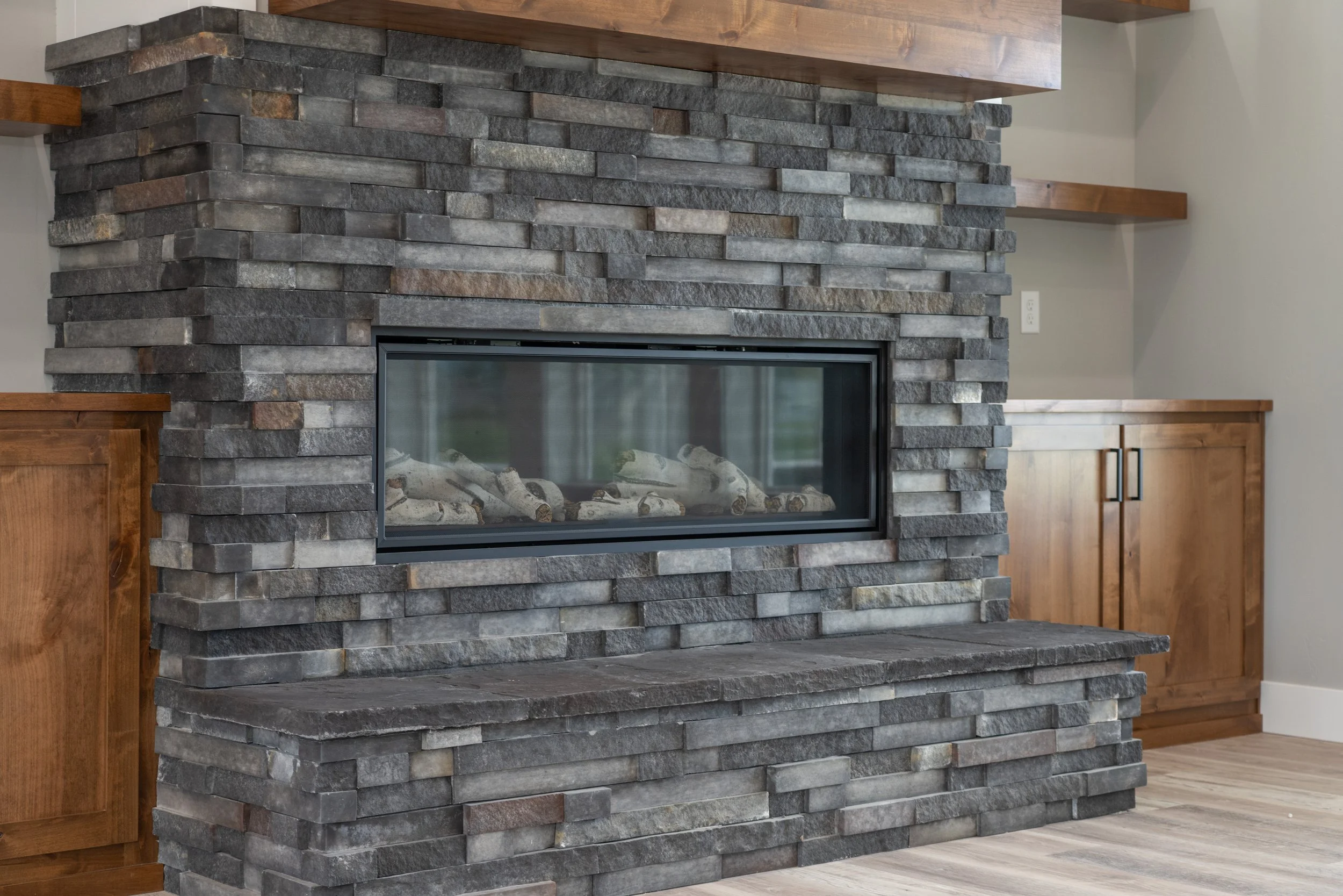 Close view of the stacked-stone fireplace surround — JAB Construction’s Modern Craftsman custom home in Idaho Falls, Idaho.