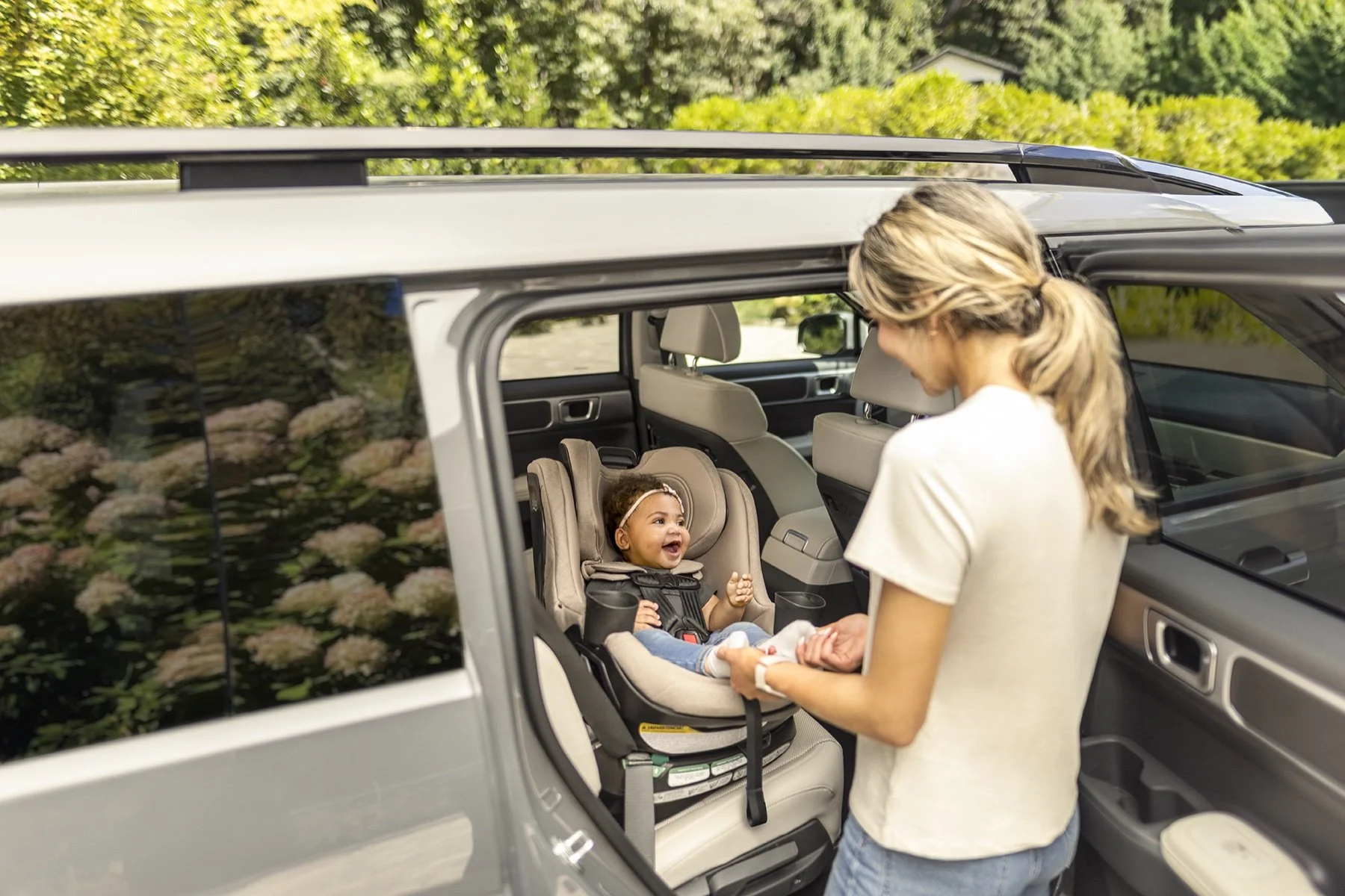 Mother placing an infant into the Britax Galaxy360 rotating convertible car seat
