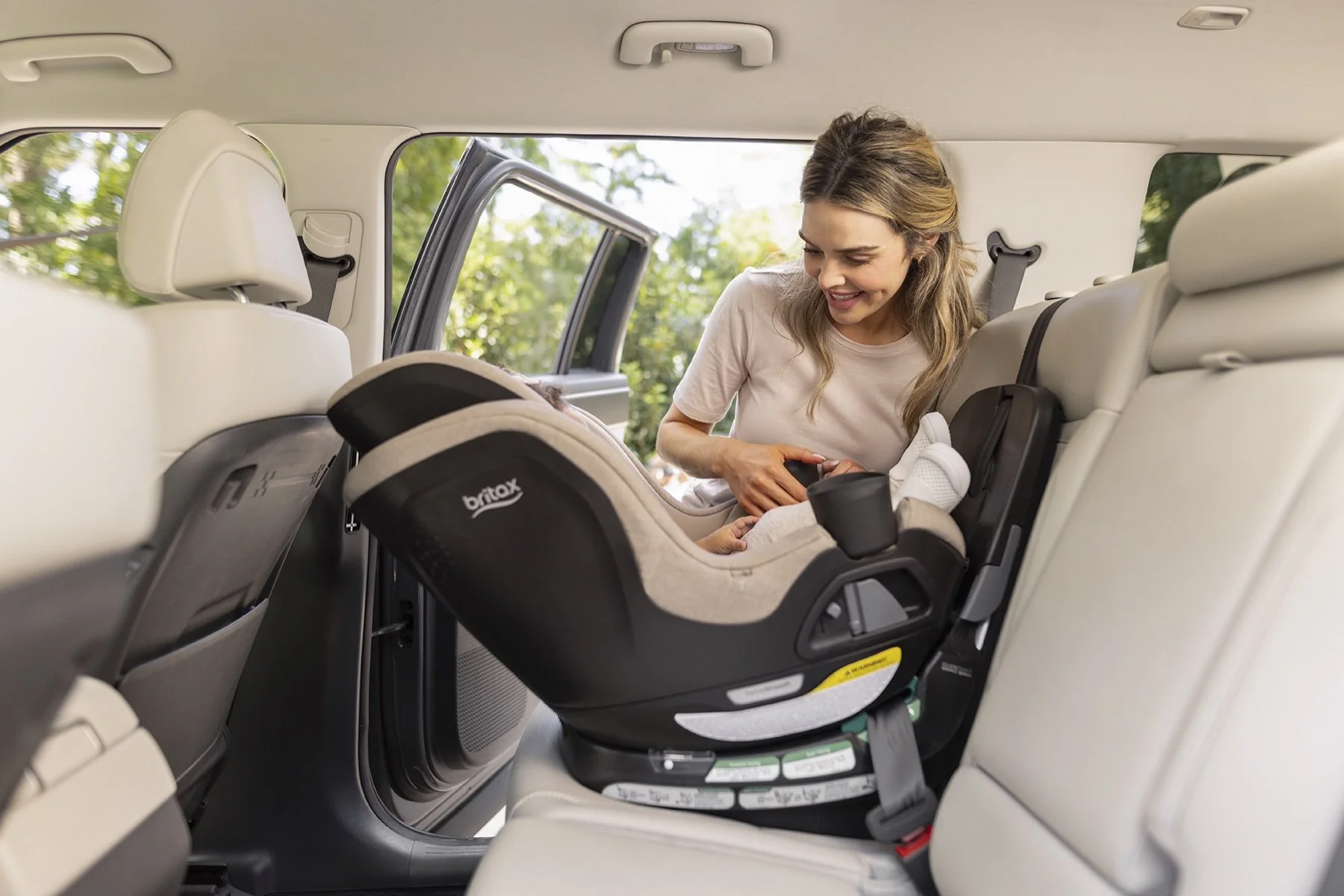 Mother and toddler beside the Britax Galaxy360 rotating car seat.