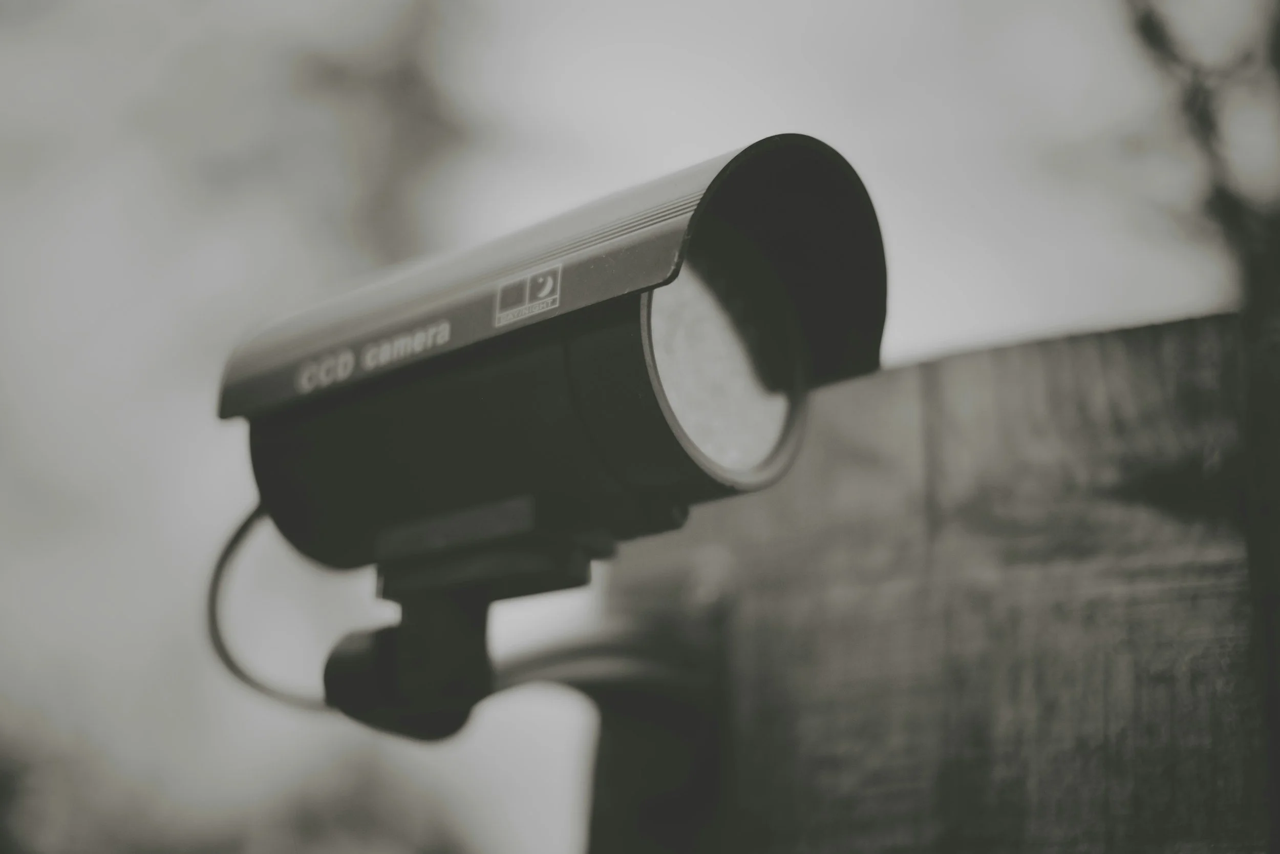 Close-up of a video surveillance camera mounted on a wall