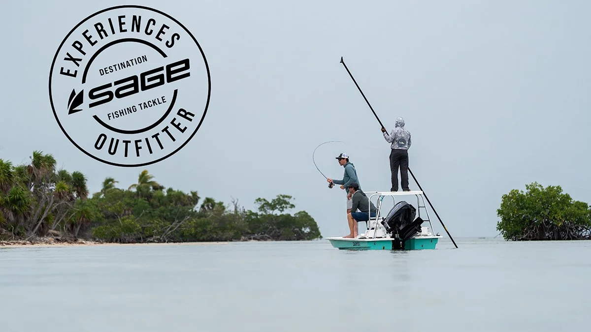 Three people fishing on a small boat in calm water near a shoreline with trees, two standing and one sitting, with a logo for Sage Outfitters on the upper left.