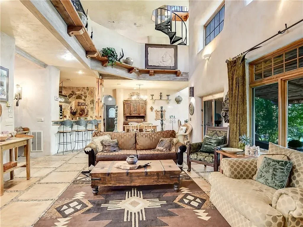texas-hill-country-living-room-rustic-spiral-staircase.webp