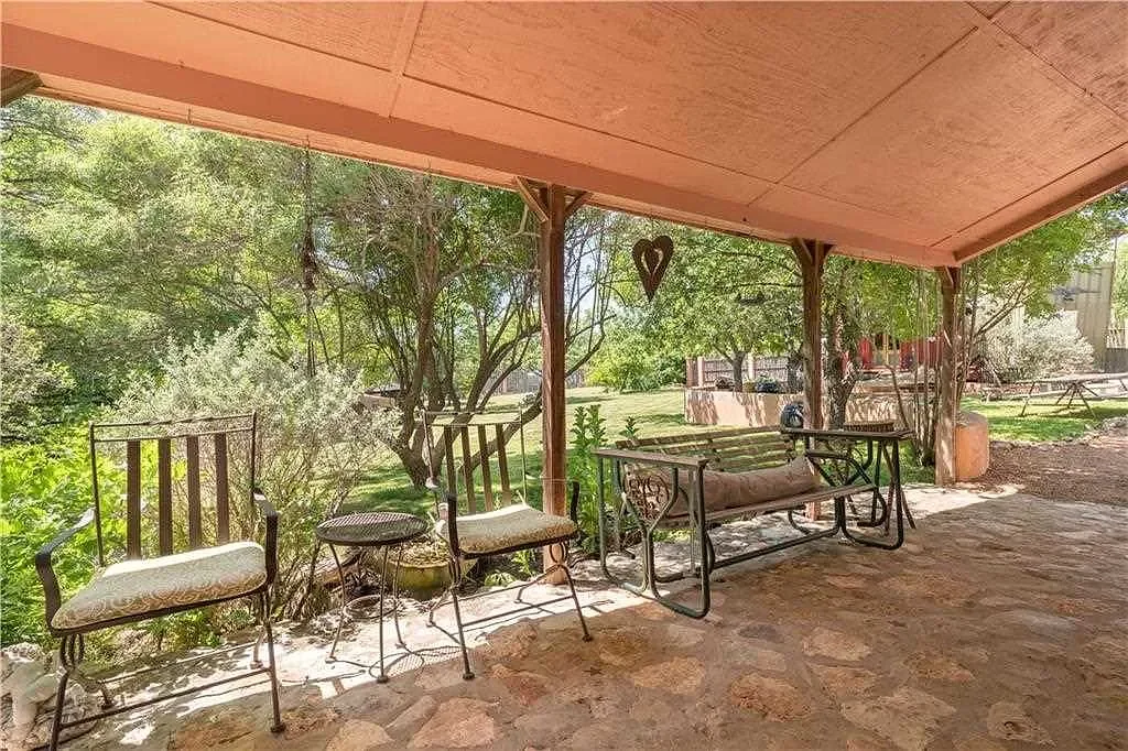 spicewood-texas-hill-country-porch-iron-furniture.webp