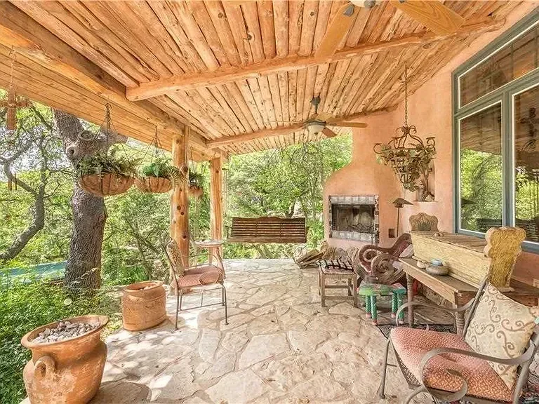 texas-hill-country-porch-rustic-swing-fireplace.webp