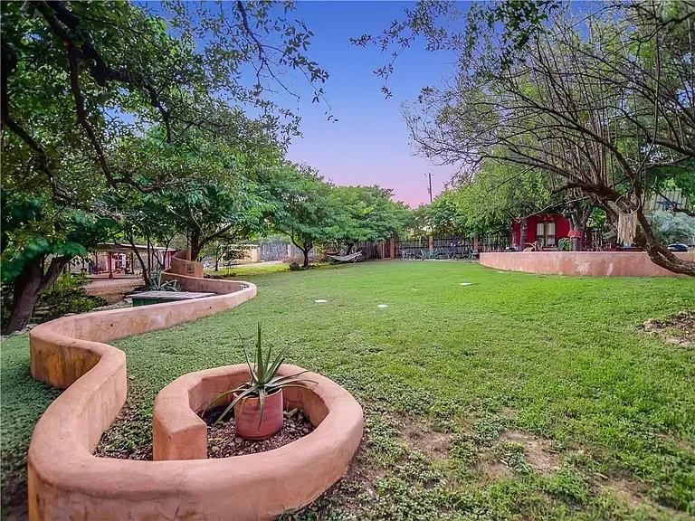 texas-hill-country-landscape-curved-terracotta-walls.webp