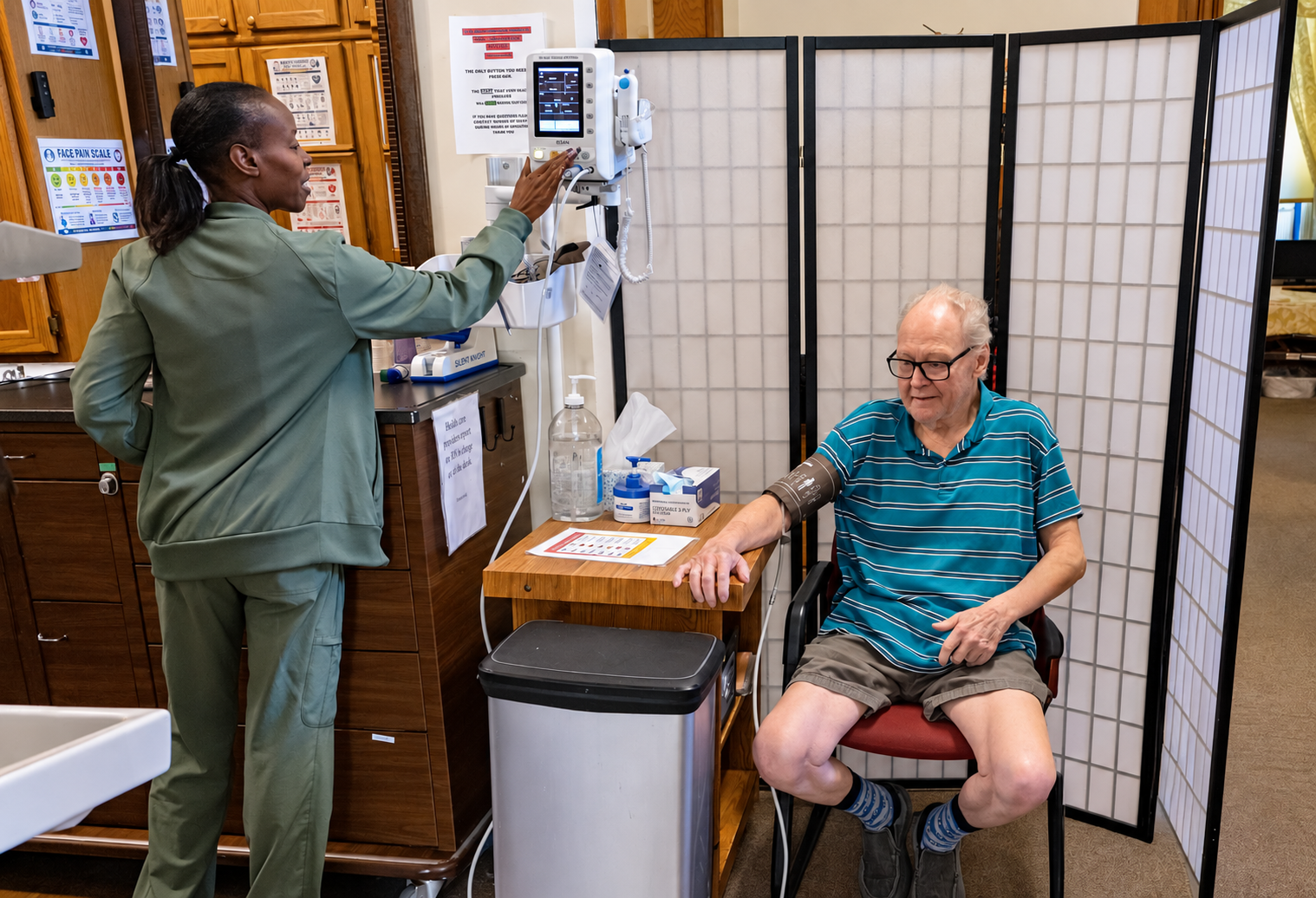 Staff member providing health monitoring and personalized care for a resident at Amy Johnson Residence assisted living in St. Paul, Minnesota.