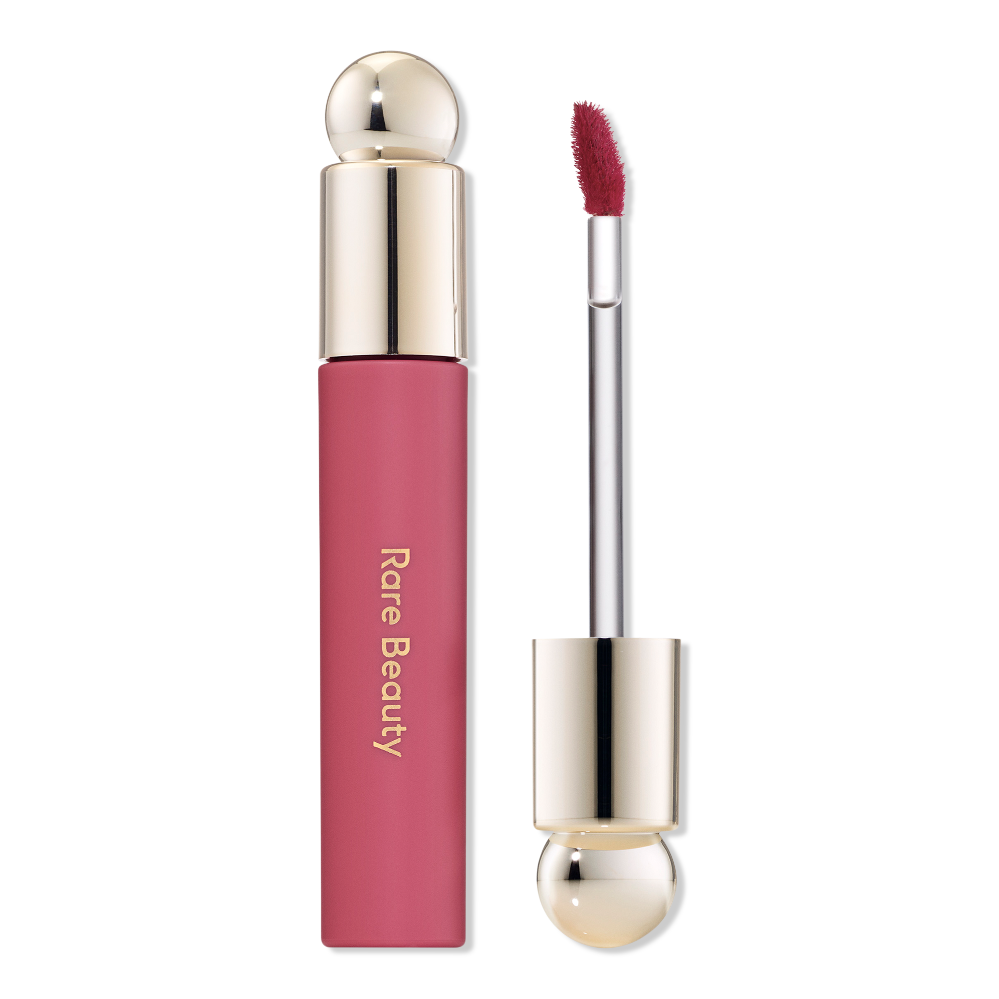 A close-up of a rose-colored lipstick tube with a shiny metallic cap next to a matching pink liquid lipstick applicator with a fuzzy tip, set against a black background.